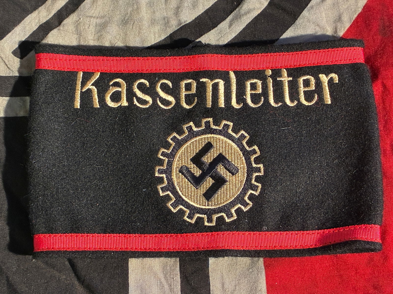 WW2 German Armband of a “Kassenleiter?? (Treasury Leader), Labour Front (DAF): This black wool armband was worn by a Kassenleiter, or Treasury Leader, within the Deutsche Arbeitsfront (DAF), the German Labour Front—the Nazi organization that replaced independent trade unions a