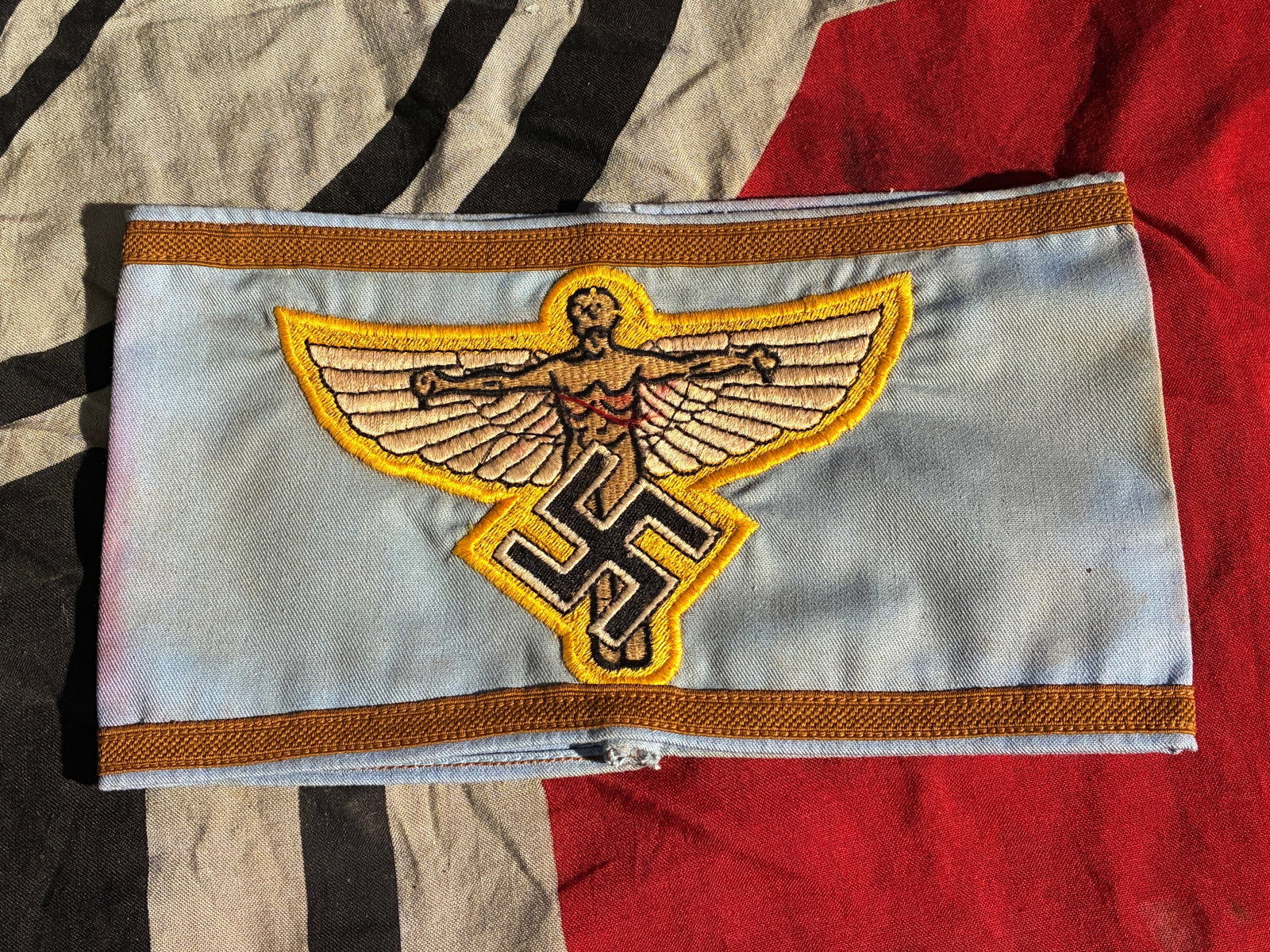WWII German NSFK Leaders armband National Socialist Flyers Corps: Beautiful and rare winged man NSFK leaders armband. The National Socialist Flyers Corps (Nationalsozialistisches Fliegerkorps; NSFK) was a paramilitary aviation organization of the Nazi Party. NSFK wa