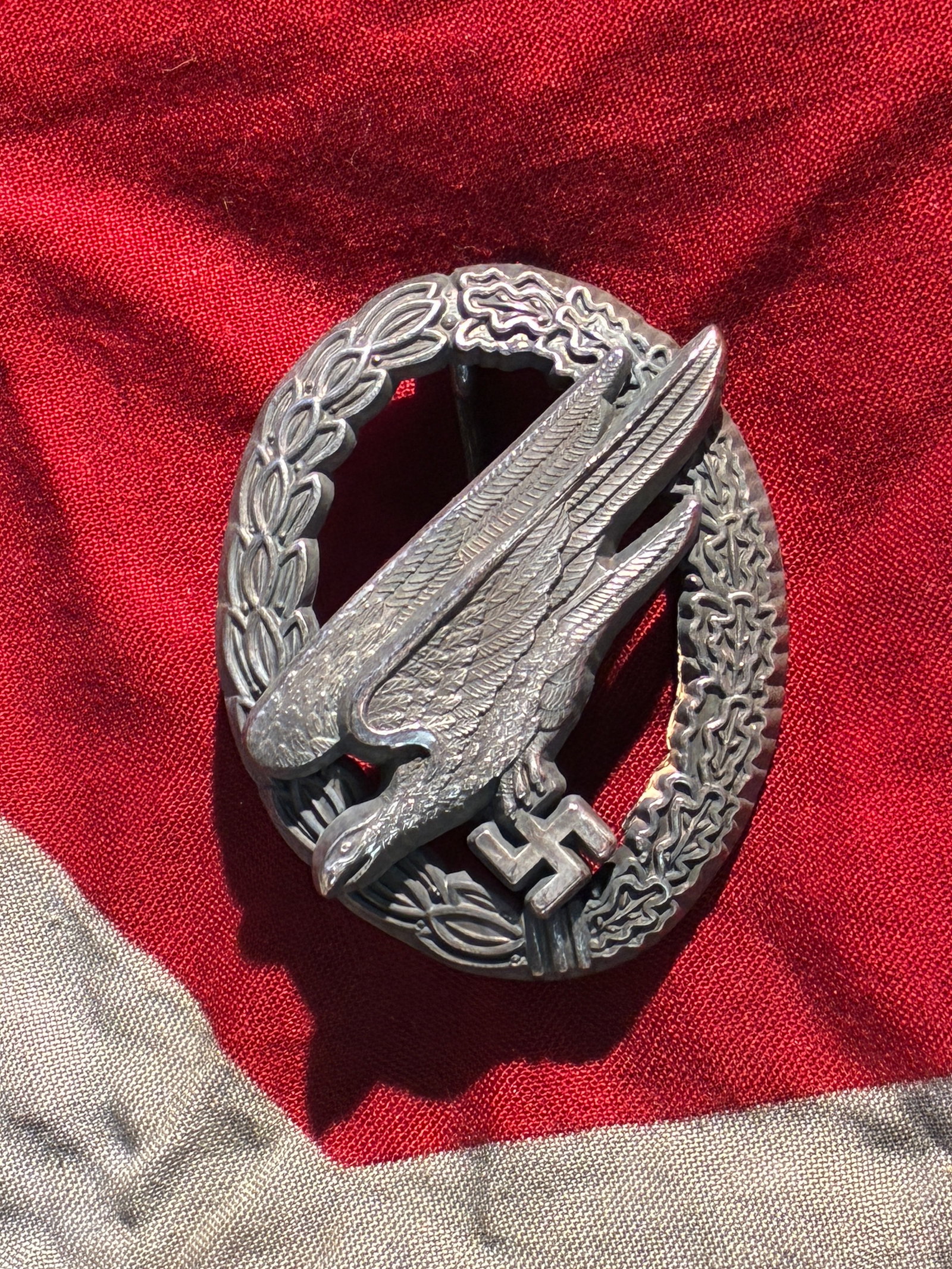 WW2 German Fallschirmschützenabzeichen der Luftwaffe (Paratrooper Badge), Marked “B&N L: This badge is a Luftwaffe Paratrooper Qualification Badge (Fallschirmschützenabzeichen), instituted in 1936 for members of Germany’s airborne forces. The design features a diving eagle clutching a 