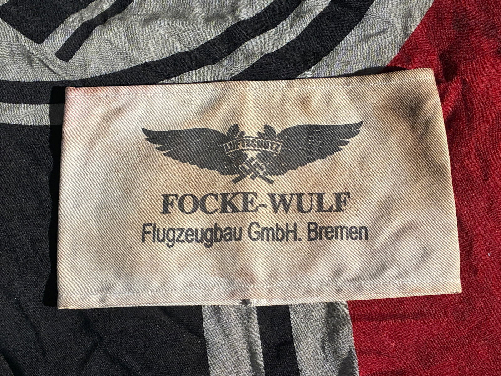 WW2 GERMAN Focke-Wulf Factory Air-Raid Warden Armband: This armband originates from the Focke-Wulf Flugzeugbau GmbH aircraft works in Bremen, a major German aviation manufacturer during the Second World War. Printed with the company name and the emblem of