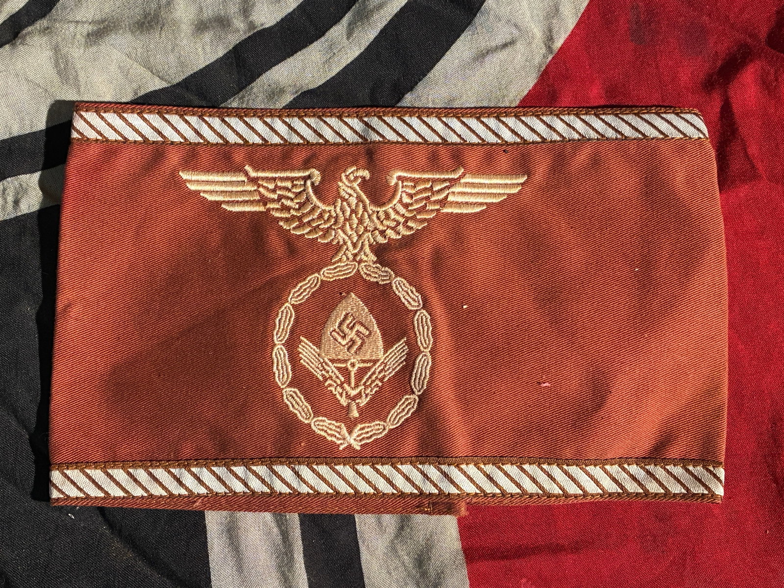 WW2 German Party Political Leader’s Armband (Ortsgruppenleitung), c. 1939–1945: This armband was worn by mid-level political leaders within the National Socialist German Workers’ Party (NSDAP) during the Second World War. The deep brown cloth reflects the Party’s official col