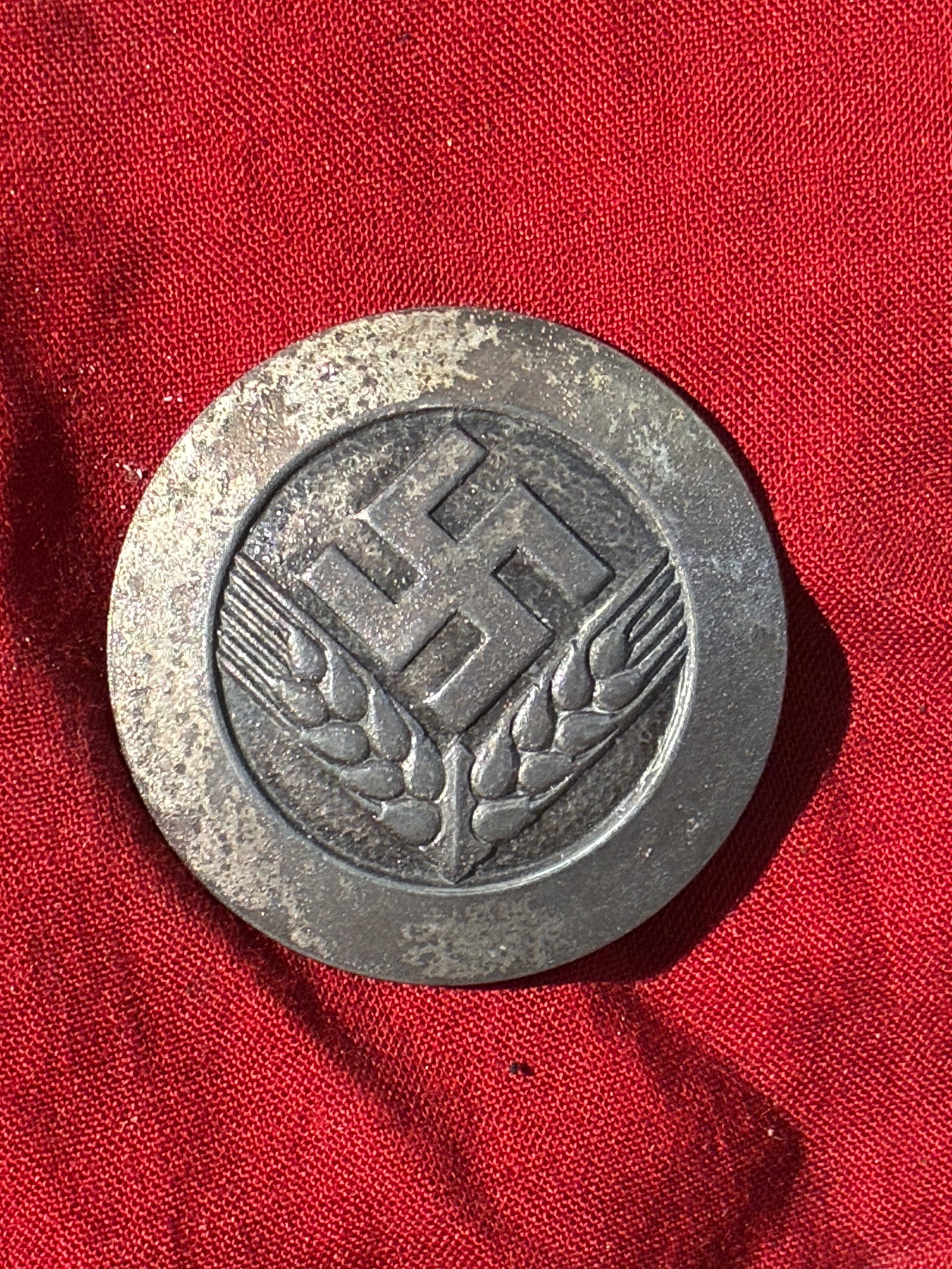 Reichsnährstand Agricultural Badge (WW2 German), ca. 1930s–1940s: This small circular badge features the symbol of the Reichsnährstand—the Nazi regime’s centralized agricultural organization created in 1933 to control German farming, food production, and rural 