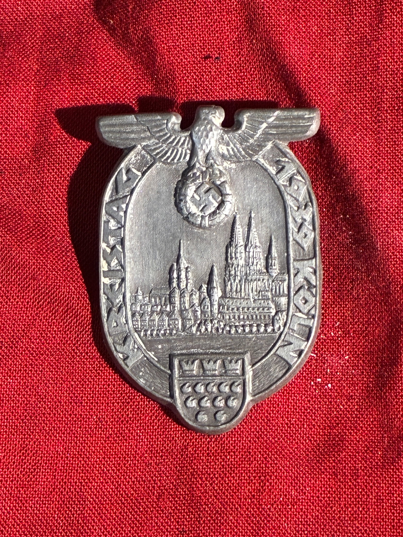 WW2 German Badge from the 1938 Party Rally in Cologne: This commemorative badge was issued for participants attending a Nazi Party gathering held in Cologne in 1938. The design features the Cologne Cathedral—an iconic symbol of the city—framed within 