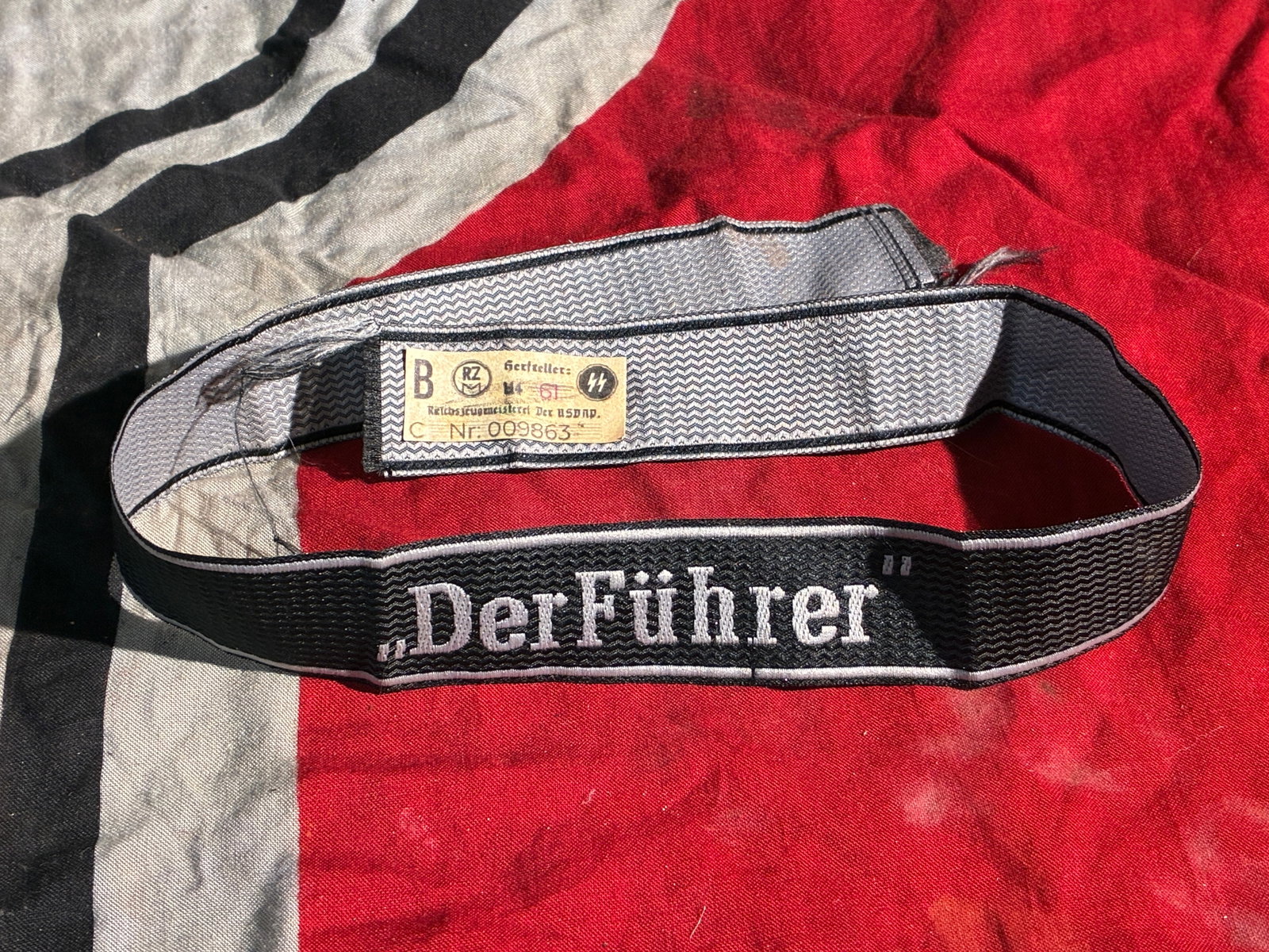 WW2 German “Der Führer?? Cuff Title of the Waffen-SS (Ca. 1940–1945): This black woven cuff title bearing the embroidered inscription “Der Führer” was part of the uniform insignia worn by members of the 2nd SS Panzergrenadier Regiment “Der Führer”, a u