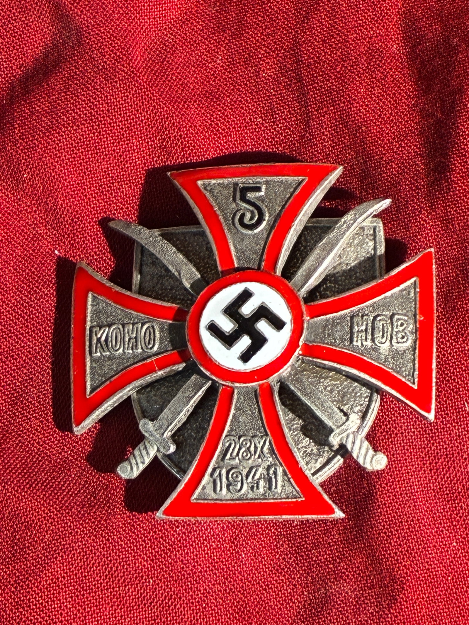 WW2 German Commemorative Badge for the 5th Don Cossack Cavalry Regiment – 28 October 1941 (German: This badge, featuring a red-enameled cross with a central swastika, was produced during the Second World War for members of the 5th Don Cossack Regiment serving under German command. The inscription �