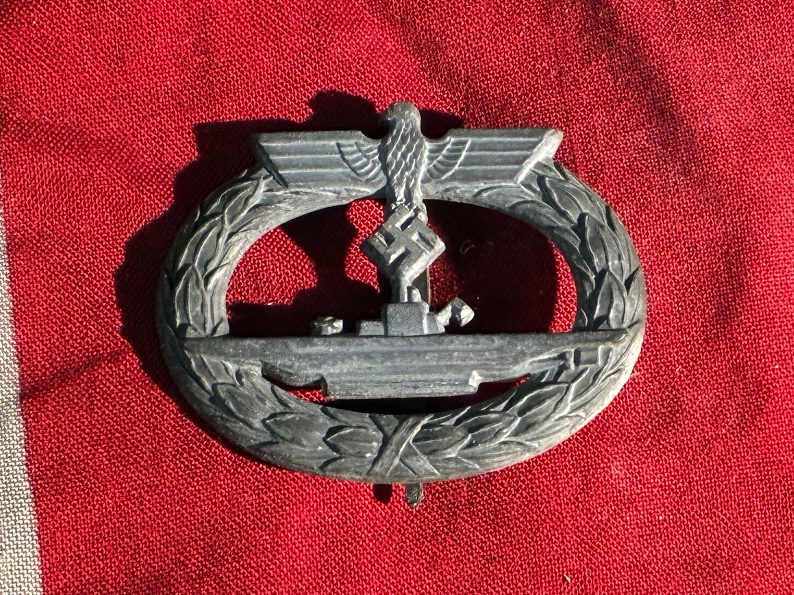 WW2 German Kriegsmarine U-Boat War Badge (U-Boots-Kriegsabzeichen), 1939–1945: This badge is an example of the Kriegsmarine U-Boat War Badge, awarded by Nazi Germany during the Second World War to U-boat crewmen in recognition of their active combat service. The design features