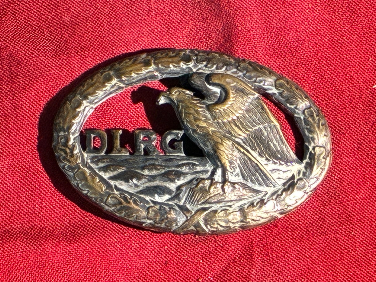 WW2 German Lifesaving Association (DLRG) Badge: This badge represents the Deutsche Lebens-Rettungs-Gesellschaft (DLRG), the German Lifesaving Association, founded in 1913 to promote water safety and rescue training. Featuring an eagle perched above