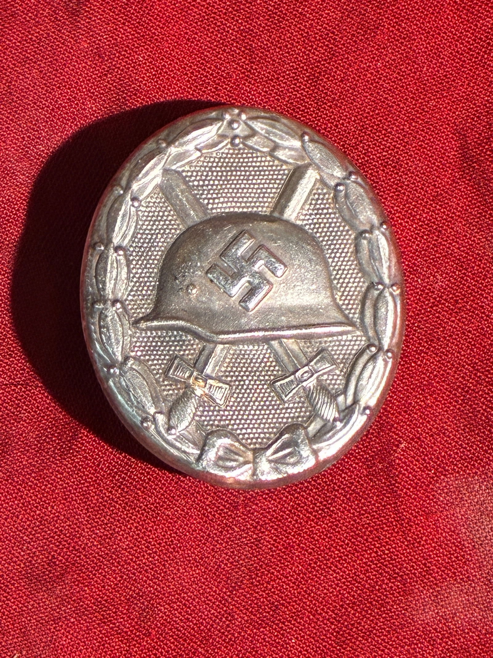 Wound Badge in Silver (Verwundetenabzeichen) – WW2 Germany, 1939 Pattern: This badge is an example of the Silver Grade Wound Badge, instituted by Nazi Germany and awarded to military personnel who sustained three or four combat wounds, or suffered injuries of equivalent sev