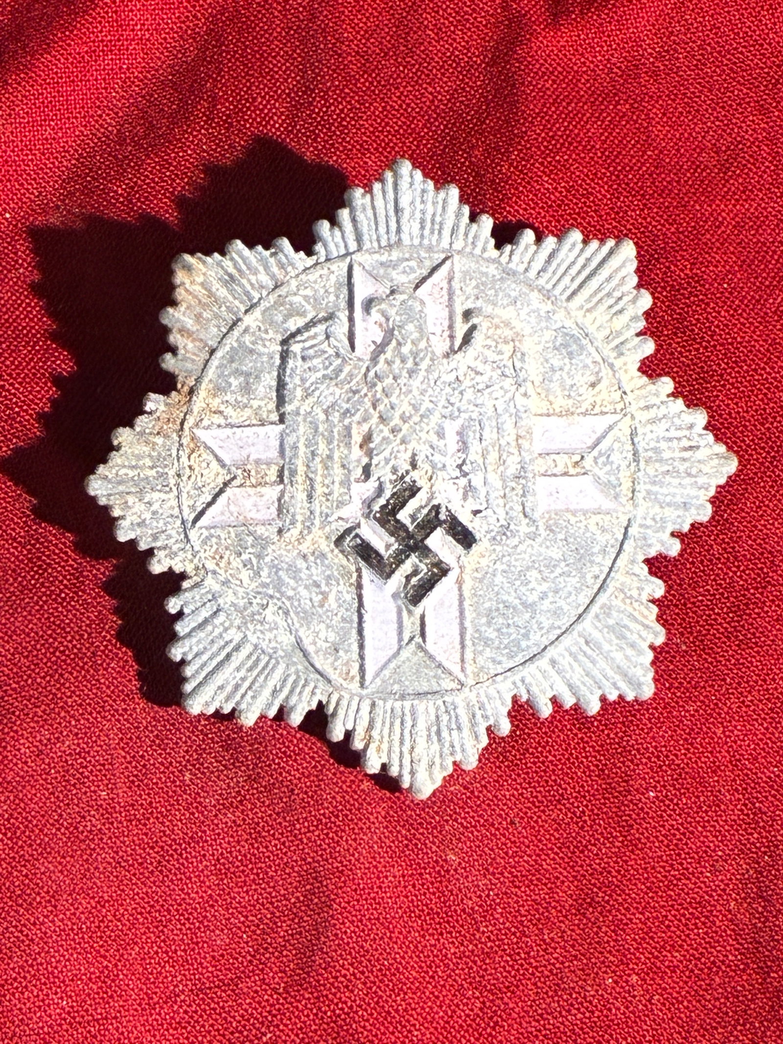 WW2 German Police Service Medal (Possibly SS or Ordnungspolizei) – Reverse Screw-Back Variant (c.: This star-shaped badge features a radiating multi-pointed design centered around the German national eagle holding a swastika—an emblem used by state and paramilitary organizations in Nazi Germany b