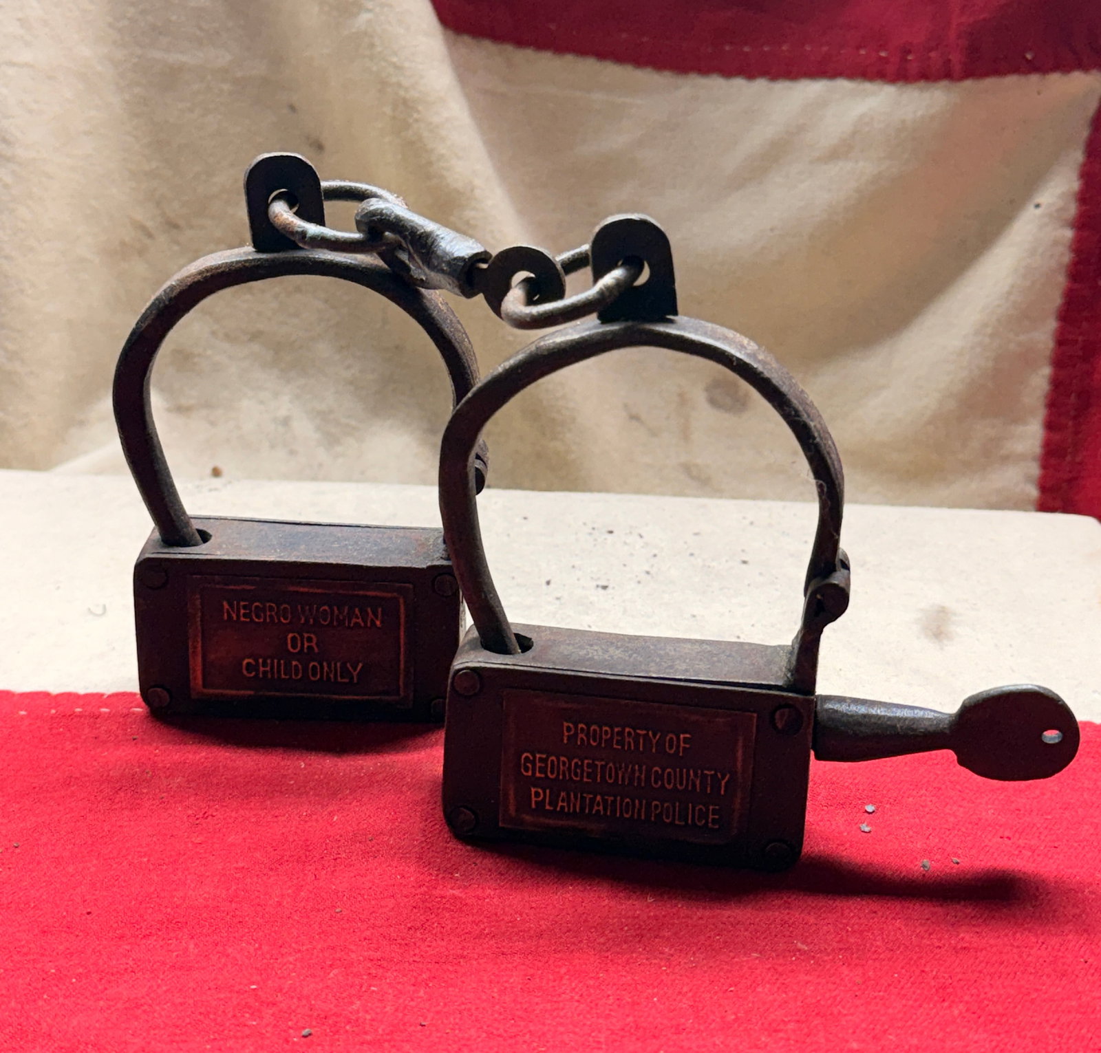 1800's Shackles for Enslaved African American Woman or Child: These iron restraints are a rare and disturbing example of the equipment used to control enslaved African Americans in the United States during the era of chattel slavery. The shackles bear two engrav