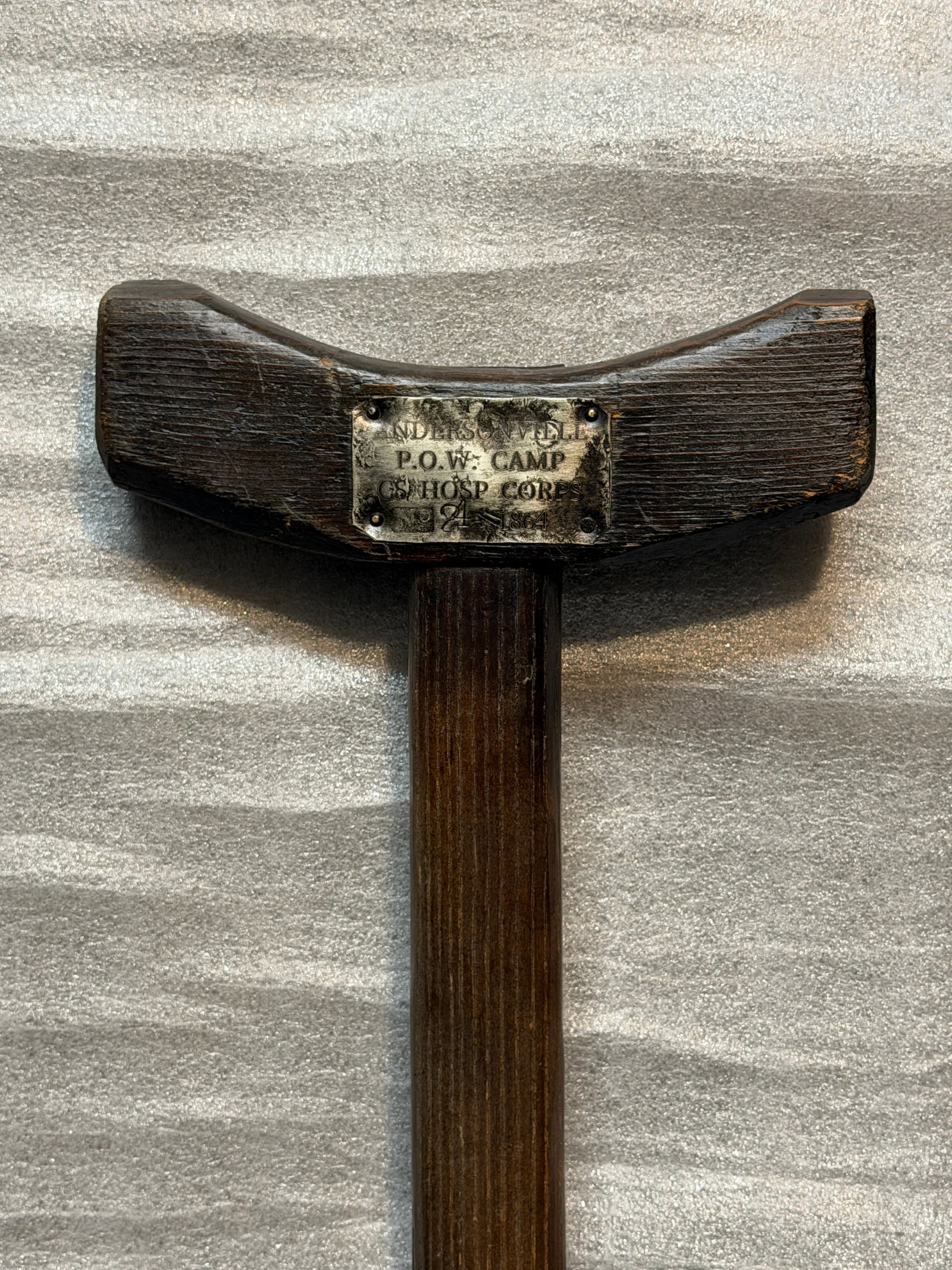 Crutch of Survival – Andersonville Prison Hospital Corps, 1864: This wooden crutch, worn smooth by desperate hands, stands as a rare and haunting artifact from Andersonville—the infamous Confederate prisoner-of-war camp officially known as Camp Sumter. Affixed t