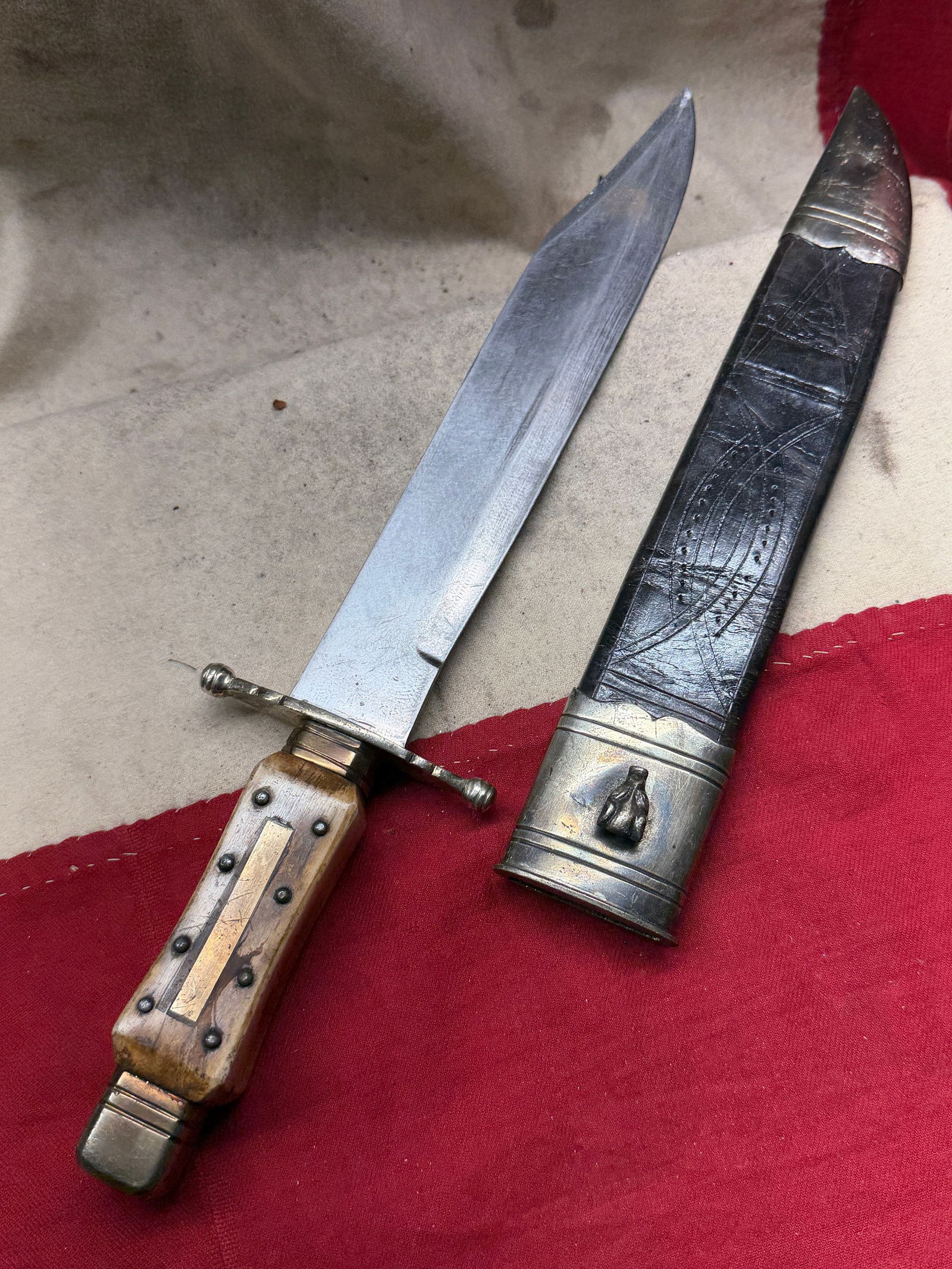 1800's Mappin Brothers Sheffield Coffin-Handle Bowie Knife with Embossed Sheath: This striking Bowie knife, manufactured by the renowned Mappin Brothers of Sheffield, England, represents one of the most iconic blade styles carried in America during the mid-19th century. Sheffield