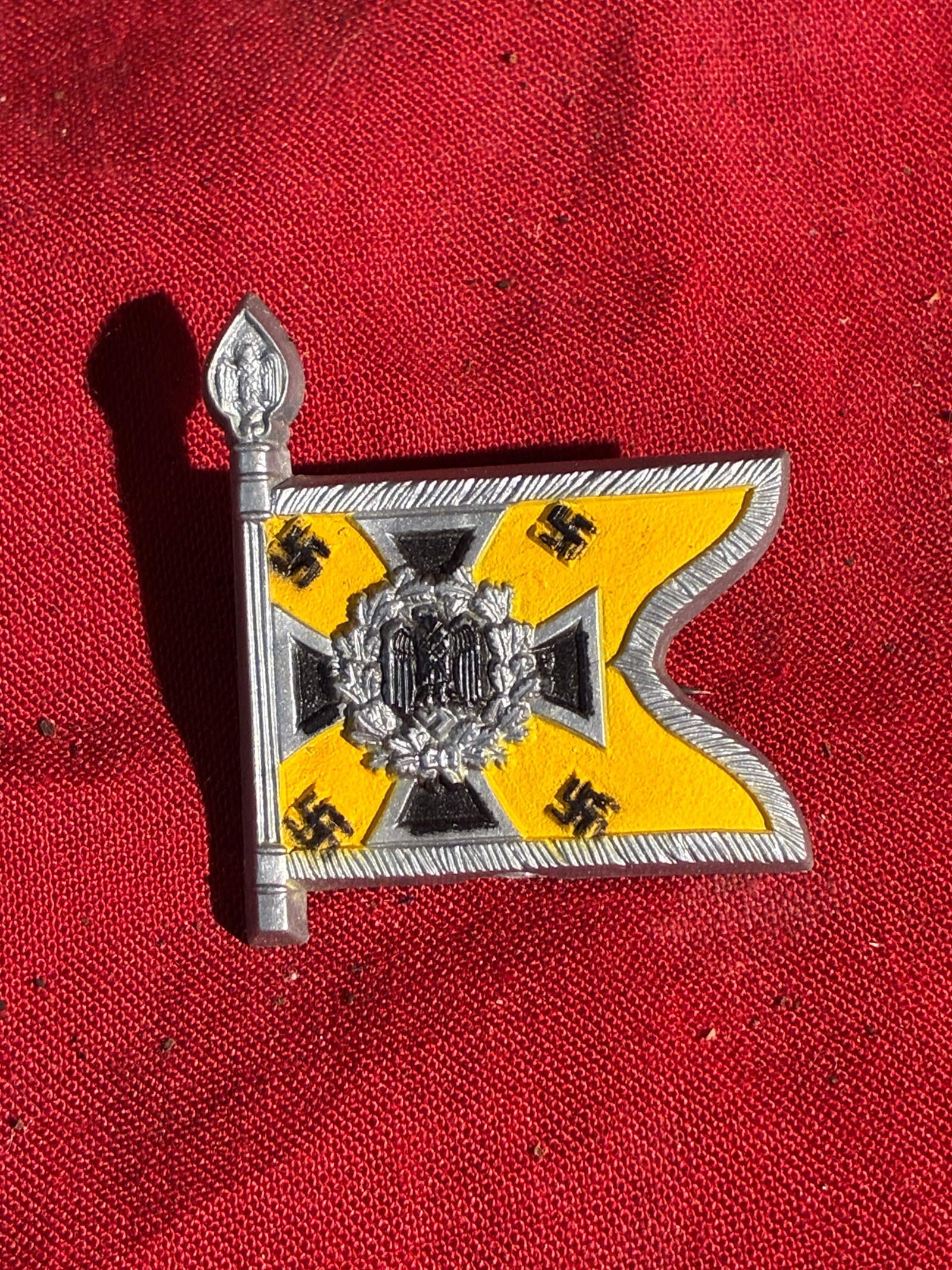 WW2 German Cavalry Unit Cap/Uniform Badge (Kavallerie): This small metal badge, marked “Kavallerie” on the reverse, represents the standard (flag) of a cavalry unit within Nazi Germany’s military structure during the Second World War. The design 