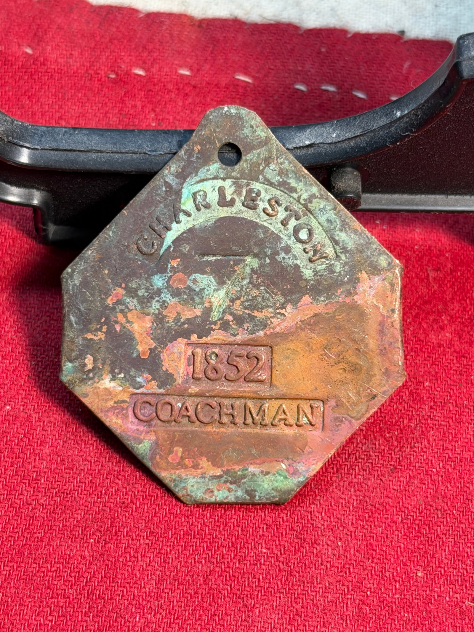 1852 Charleston Slave Tag – Coachman / Servant Identification Badge: This octagonal brass tag, issued in Charleston, South Carolina in 1852, is an authentic slave identification badge—commonly called a slave tag—used to regulate the labor of enslaved and hired-out 