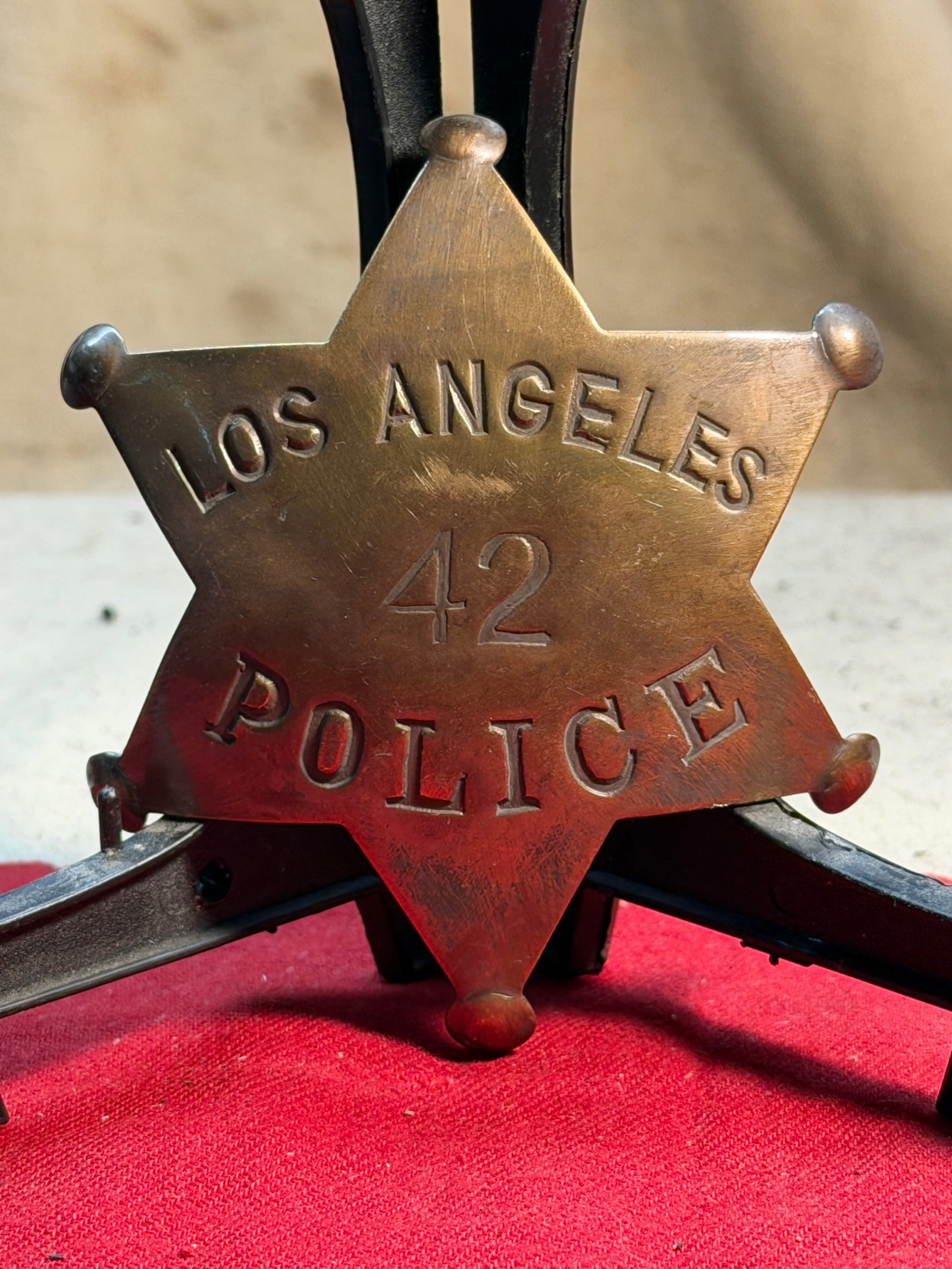 Early Los Angeles Police Star Badge No. 42 (c. late 19th–early 20th century): This six-point brass star badge, stamped “LOS ANGELES POLICE – 42”, represents one of the early forms of law-enforcement identification used by the Los Angeles Police Department during a for