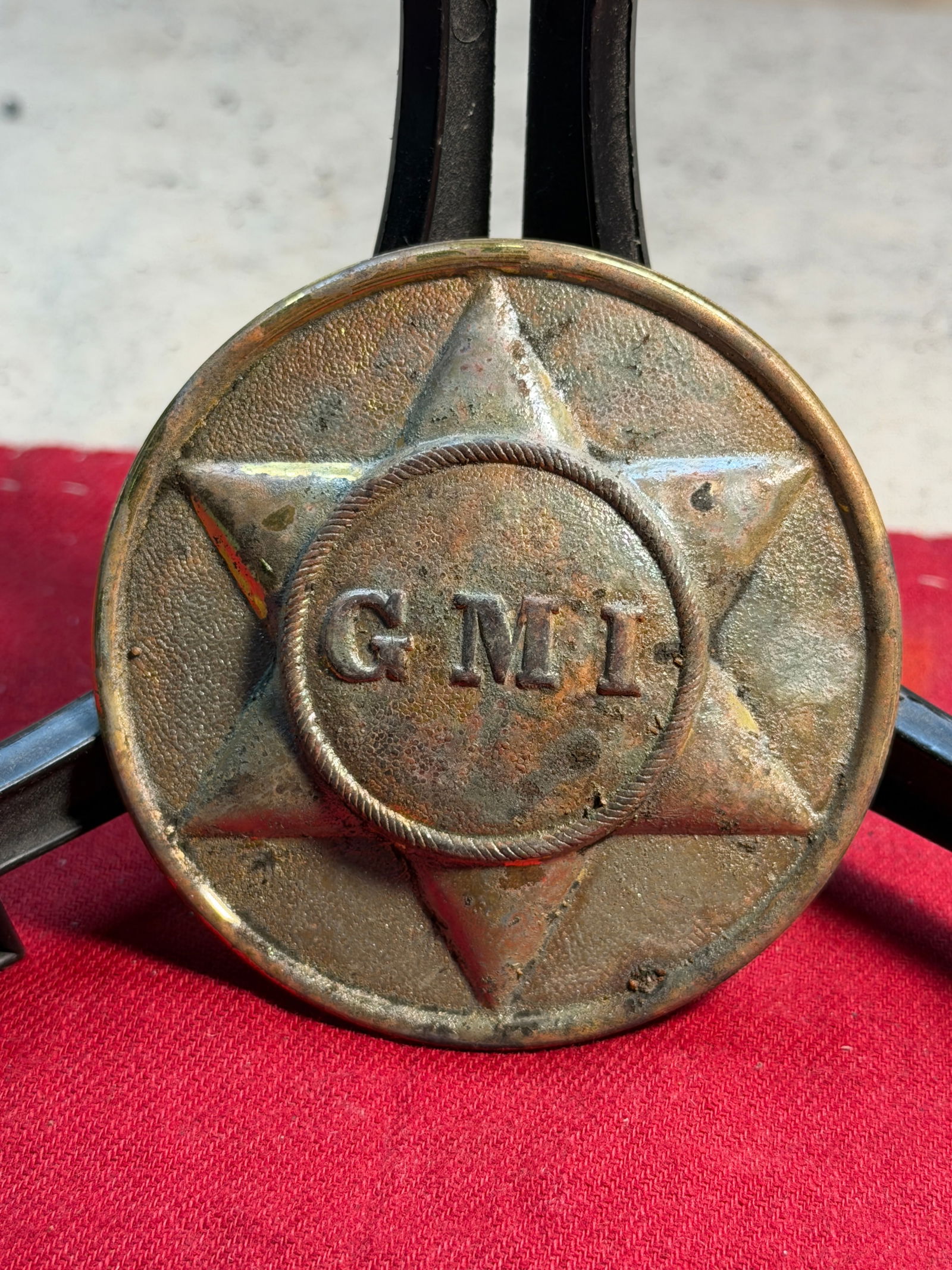 Civil War Georgia Military Institute Cadet Breast Plate (c. 1861–1864): This brass breast plate, embossed with a six-point star surrounding the initials “G.M.I.”, is attributed to the Georgia Military Institute (GMI) during the American Civil War. Worn on a crossb