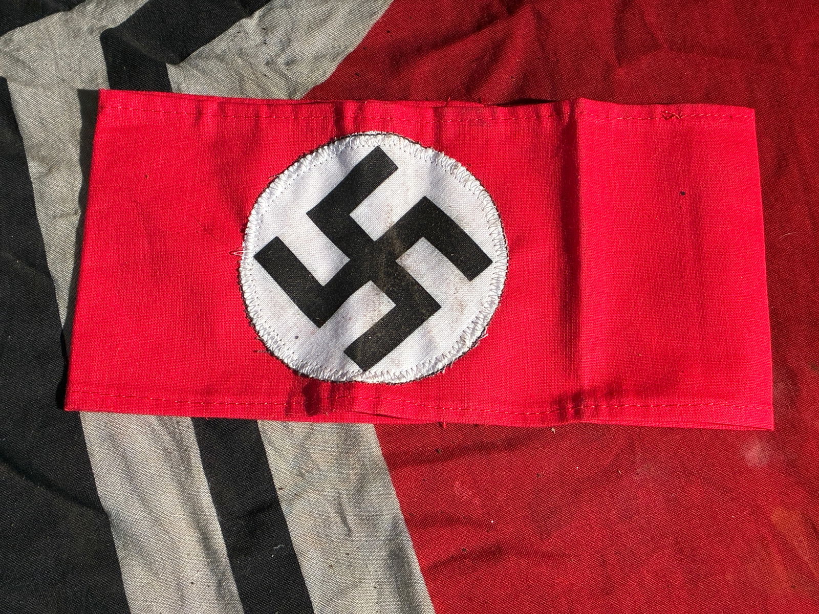 WW2 German Party Armband (NSDAP): This textile armband was worn by members of the National Socialist German Workers' Party (NSDAP) during public events, rallies, and political functions in Nazi Germany. Constructed of red cotton with