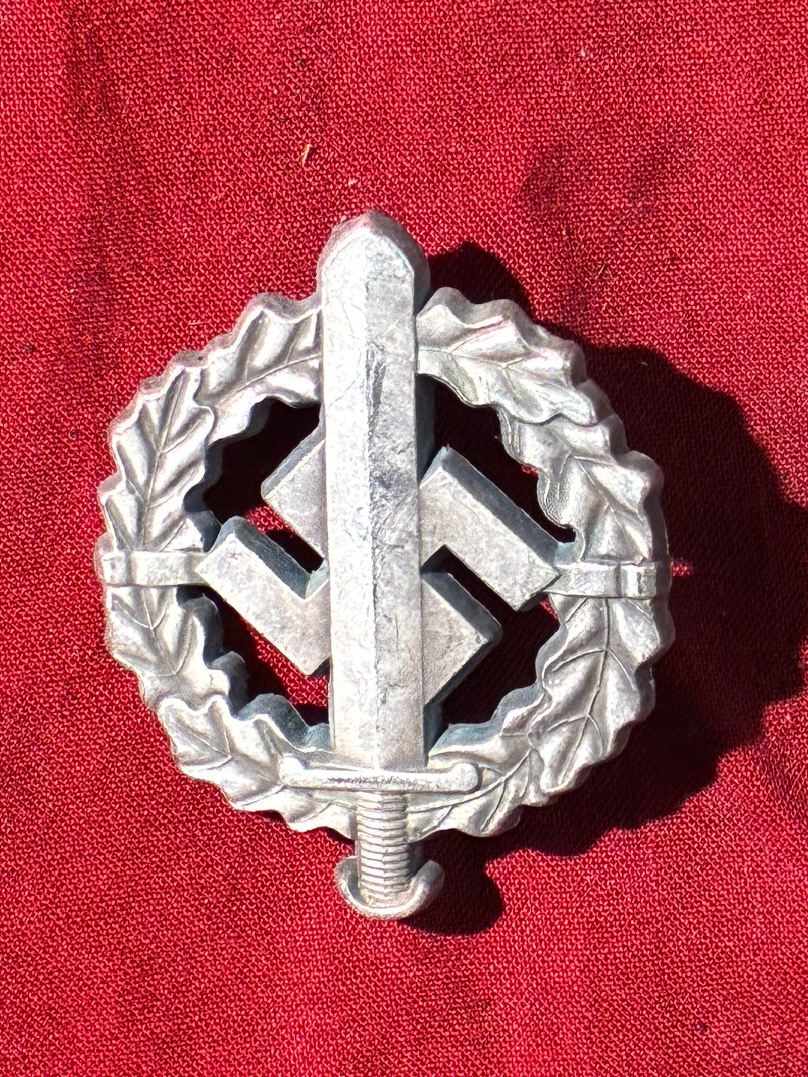 WW2 German Sturmabzeichen der SA (SA Sports Badge), Early Pattern: This badge represents an early form of the SA Sports Badge, instituted by the Sturmabteilung (SA) in 1933 as part of the National Socialist physical training program. The design features a vertical sw