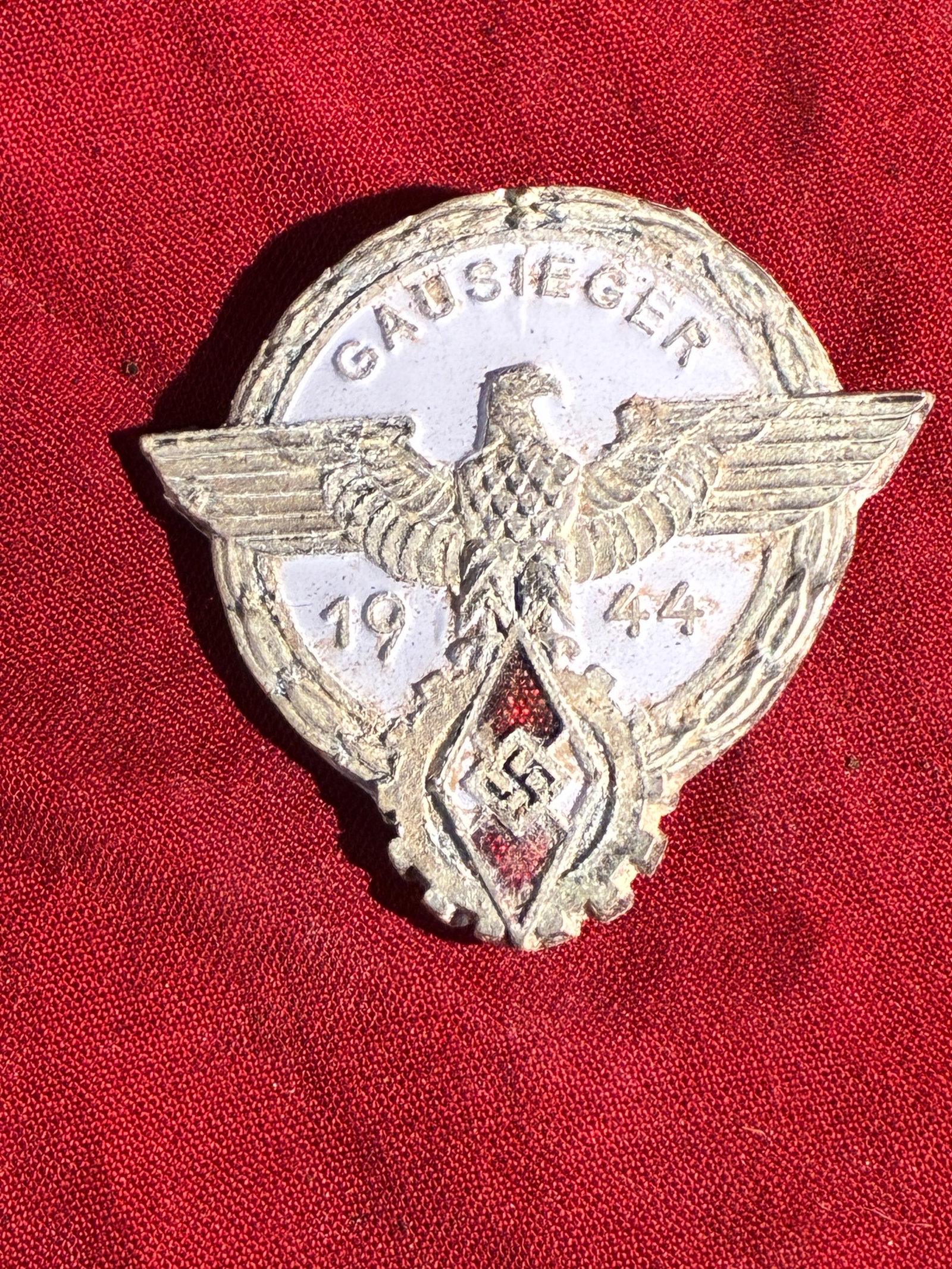 WW2 German 1944 Gausieger Hitler Youth Competition Badge By Brehmer: This heavily weathered badge is an original Gausieger (“District Champion”) award from 1944, issued during the final years of the Third Reich. Badges of this type were presented to regional wi