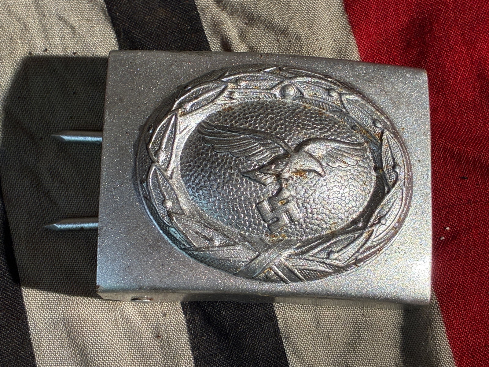 WW2 German Luftwaffe Enlisted/NCO Belt Buckle (c. 1936–1945): This aluminum belt buckle was issued to enlisted men and non-commissioned officers of the German Luftwaffe during the Second World War. The design features the Luftwaffe’s spread-wing eagle clutchin