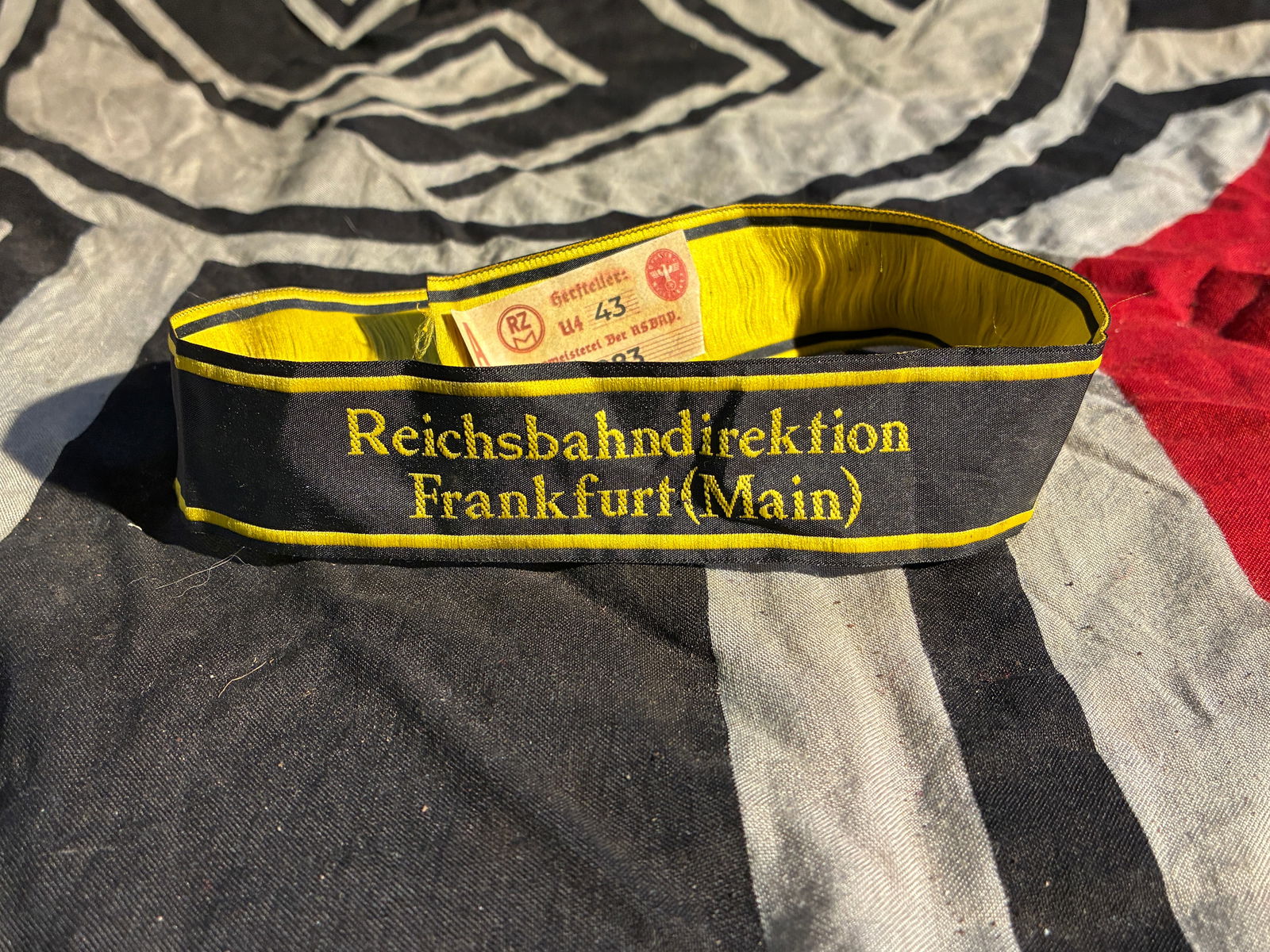 WW2 German Reichsbahndirektion Frankfurt (Main) Cuff Title With RZM Paper Tag: This cuff title was issued to personnel of the Reichsbahndirektion Frankfurt (Main), a regional administrative directorate of the German National Railway during the era of the Third Reich (1933–1945