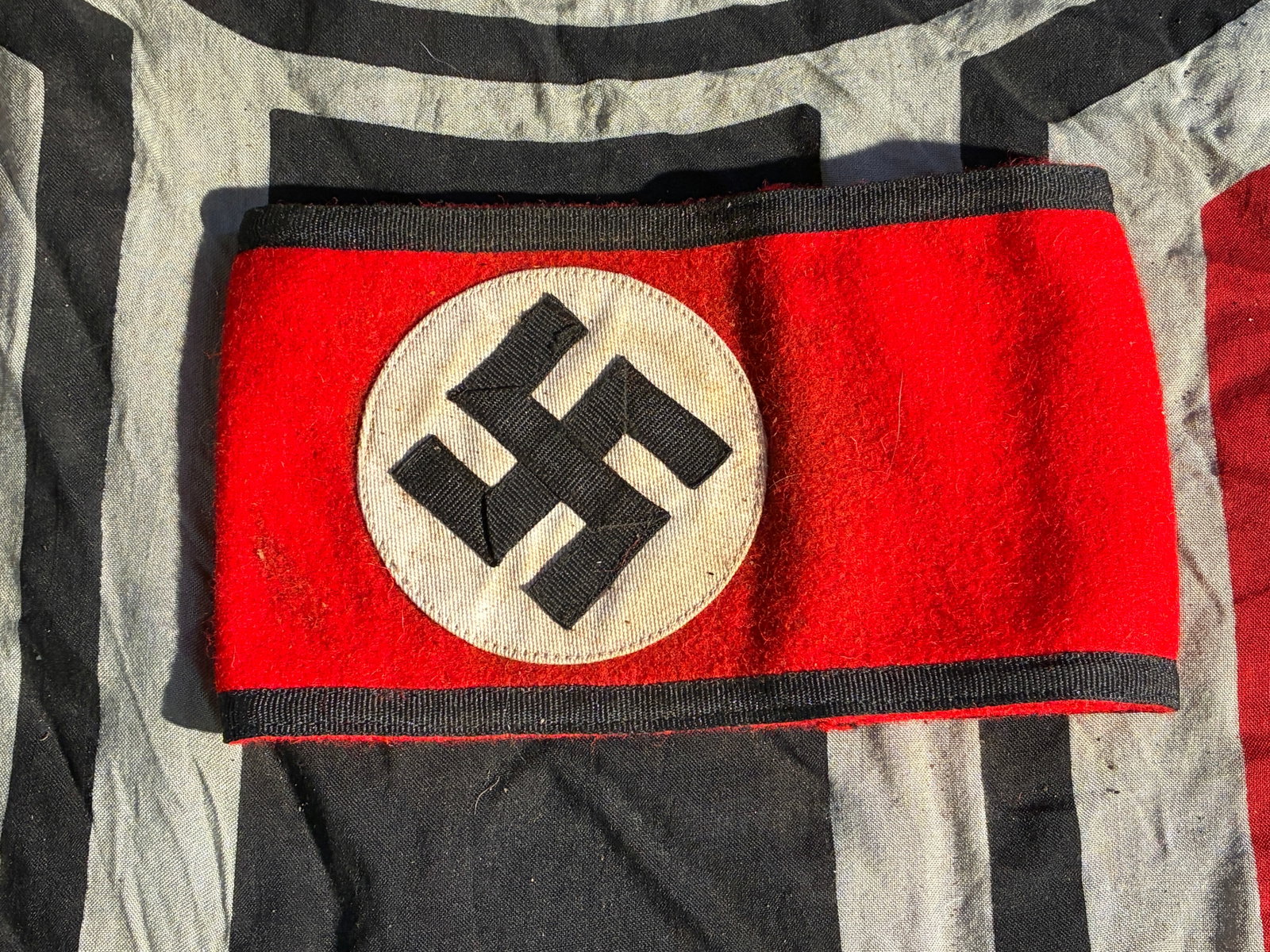 WW2 German Party Armband (Purported SS-Marked Variant) With RZM Cloth Tag: WW2 German Party Armband (Purported SS-Marked Variant) With RZM Cloth Tag. This red armband bearing a black swastika within a white roundel is representative of the armbands widely worn by members and