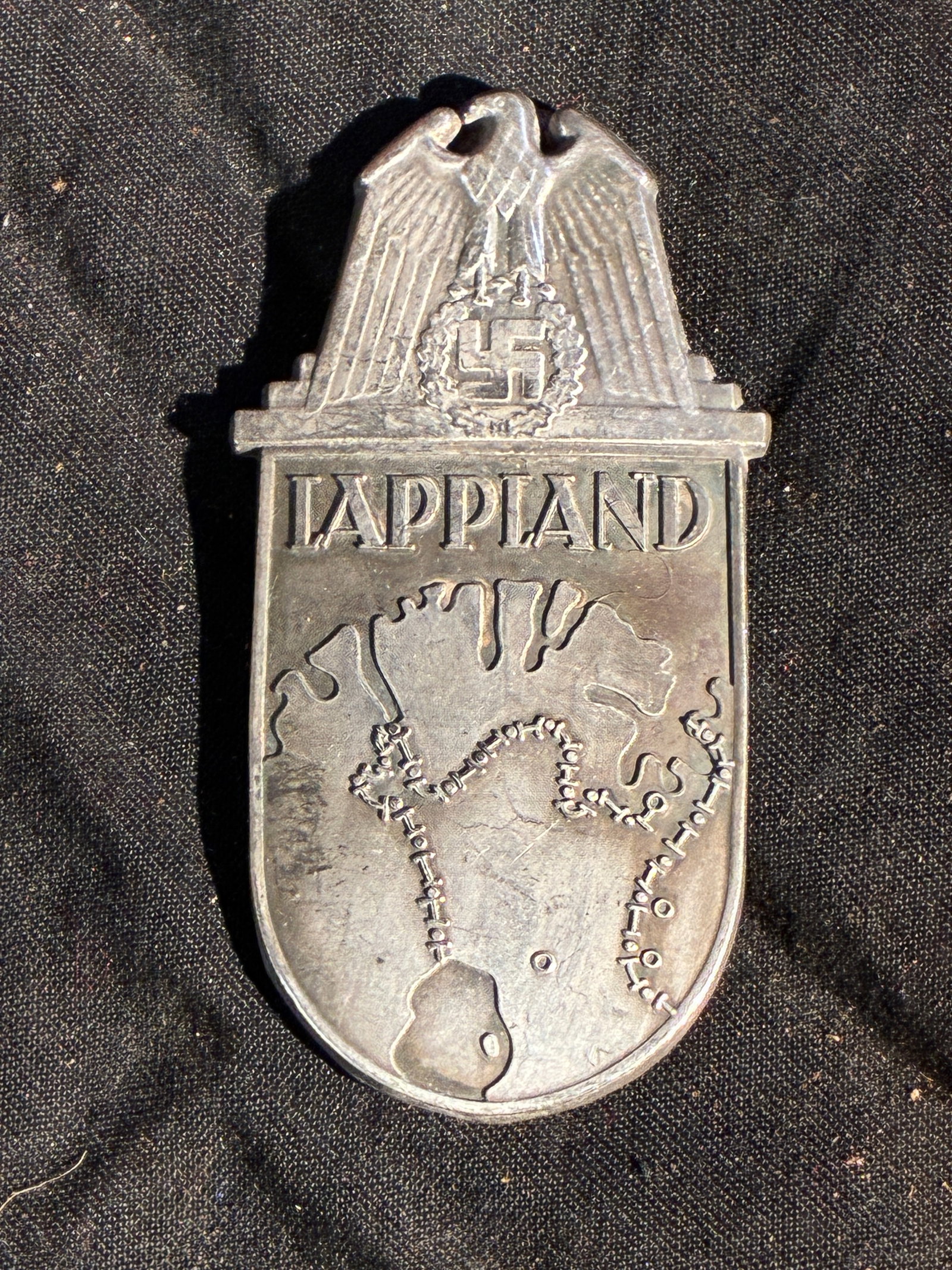 WW2 German Lappland Shield (Unofficial German Campaign Badge, 1945): This badge is an unofficial German campaign shield associated with military personnel who served in northern Finland and Norway during the final months of the Second World War. Known as the Lappland S