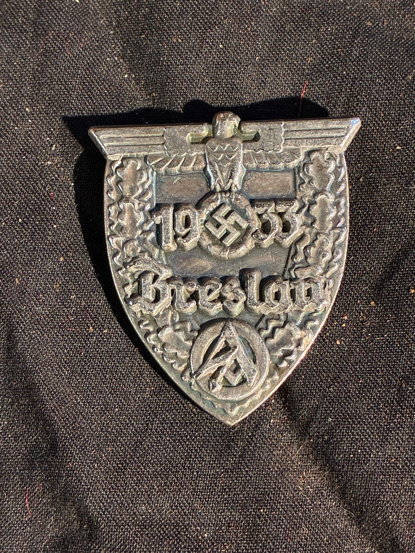 WW2 German 1933 Breslau Commemorative Badge: This metal commemorative badge was issued in Breslau (now Wroc?aw, Poland) in 1933 for a National Socialist political gathering during the early consolidation of the regime’s power. The design featu