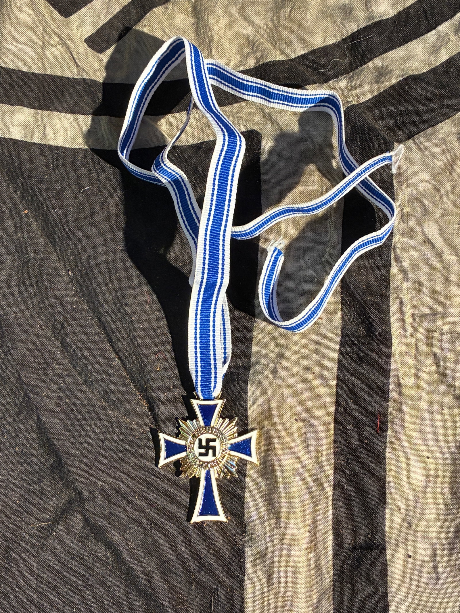 WW2 German Cross of Honour of the German Mother (Gold Grade), c. 1938: This exhibit displays an original Cross of Honour of the German Mother (Ehrenkreuz der Deutschen Mutter), instituted on 16 December 1938 under the National Socialist government of Germany. The decorat