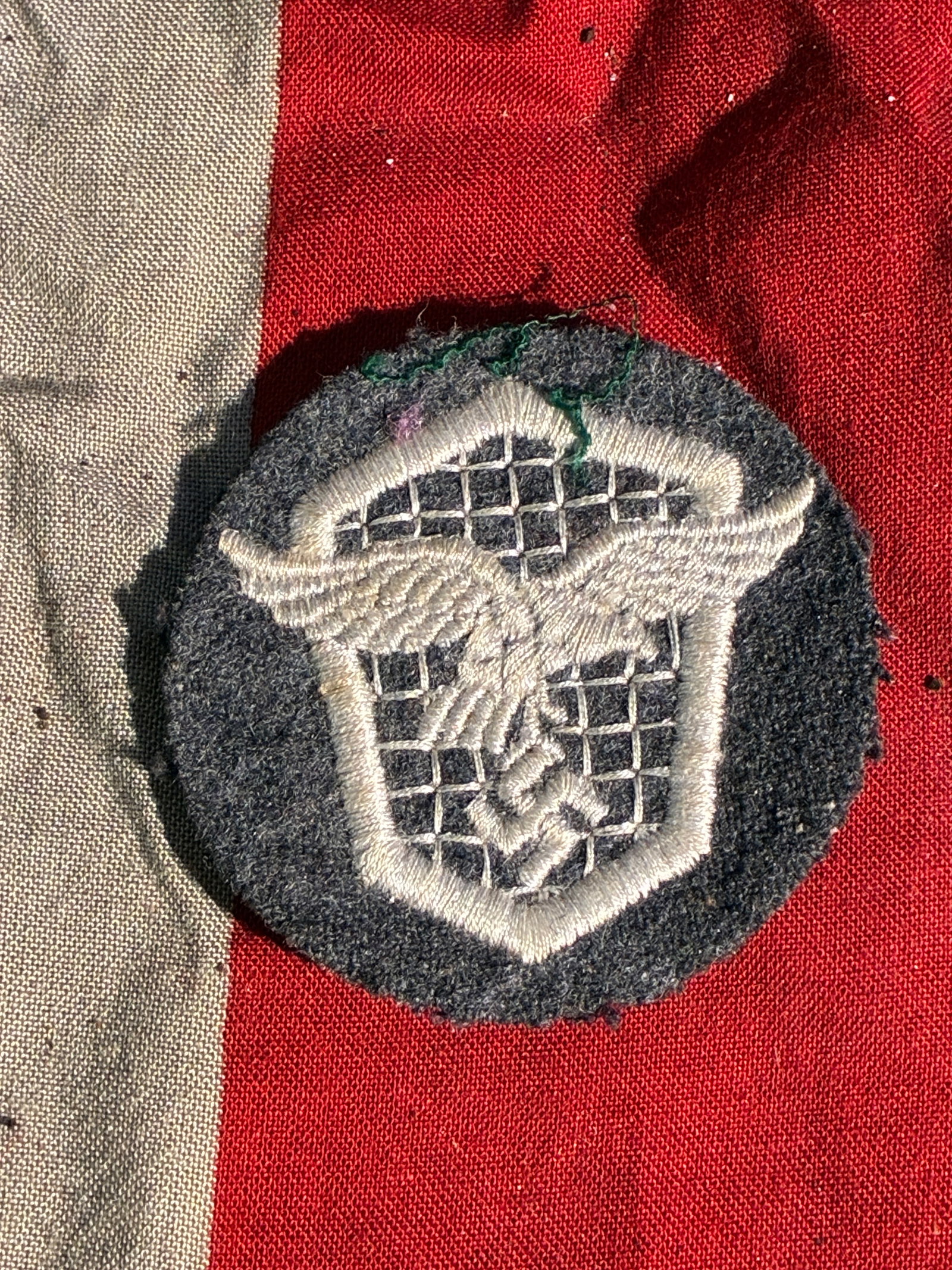 WW2 German Kraft Durch Freude (KdF) Cruise Ship Badge – Germany, c. 1930s–1940s Marked FEC. OTTO: This circular metal badge depicts the bow of an ocean liner framed by a stylized rope border. It represents the Kraft durch Freude (“Strength Through Joy,” KdF) leisure organization, a major c