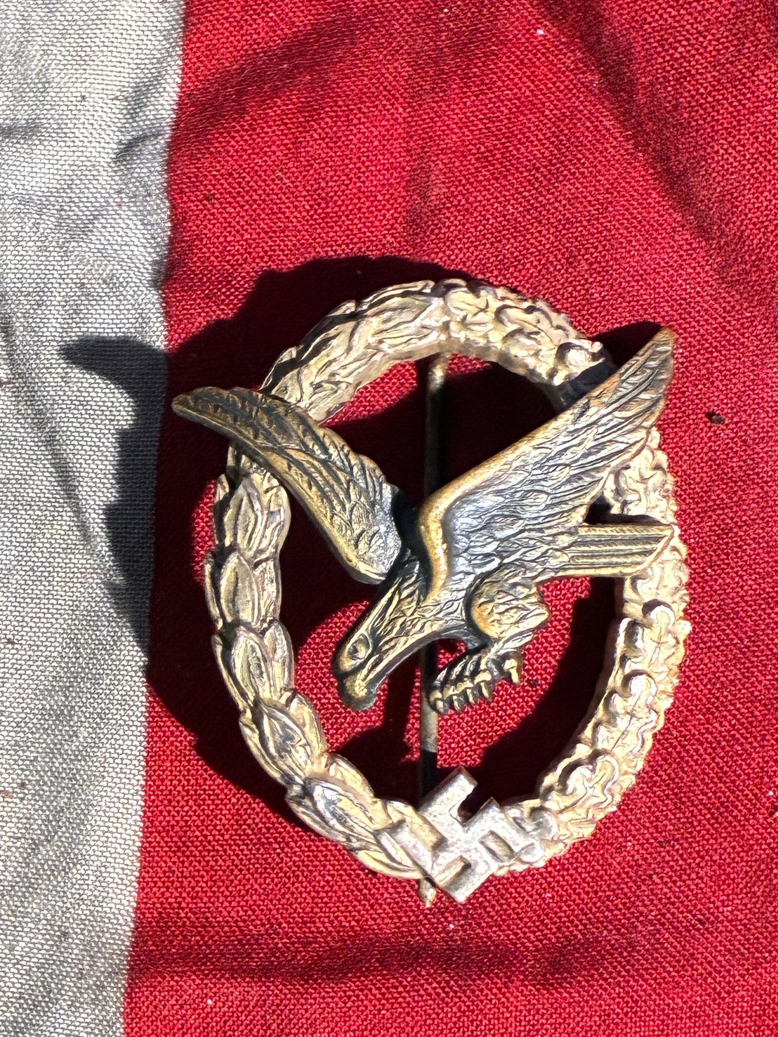 WW2 German Luftwaffe Pilot’s Qualification Badge (Germany, 1930s–1940s) By B&N: This badge served as an official qualification emblem for trained pilots of the German Luftwaffe during the period of Nazi rule. The design features a swooping eagle—symbolic of military aviation—