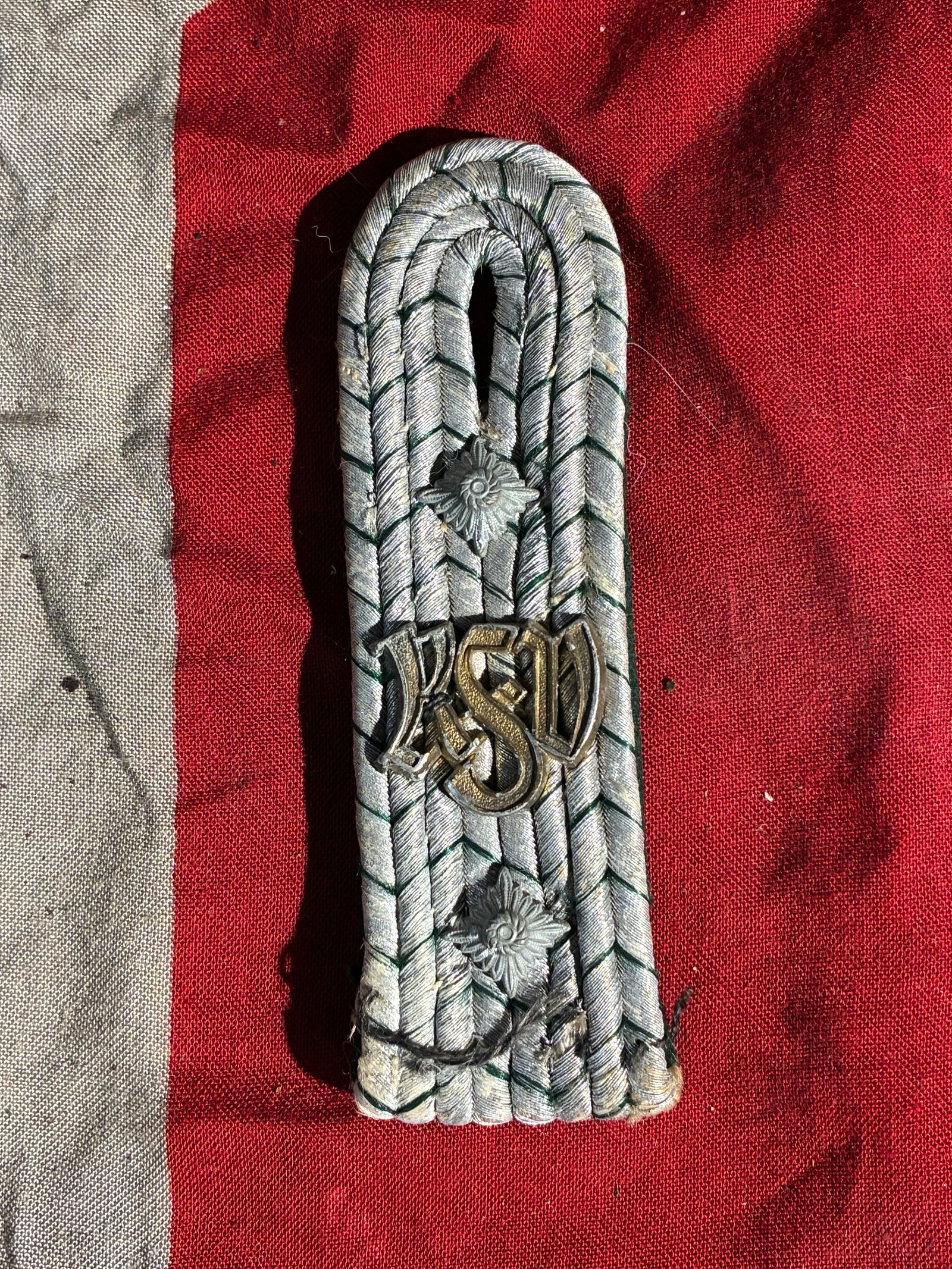 WW2 German RSD Shoulder Board (Reichssicherheitsdienst), c. 1930s–1945: This shoulder board is associated with the Reichssicherheitsdienst (RSD), the security organization responsible for protecting senior Nazi leadership during the Third Reich. The board features interwo