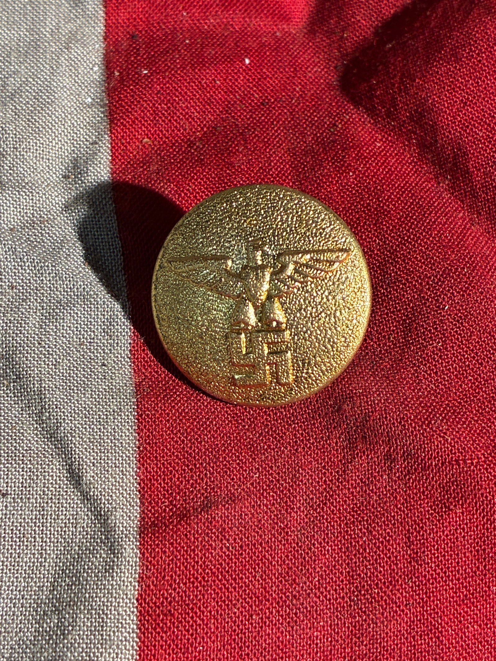 WW2 German NSDAP Uniform Button (RZM–Marked), ca. 1930s–1940s: This circular brass button was part of a standardized uniform used by organizations within the National Socialist German Workers’ Party (NSDAP) during the 1930s and early 1940s. The obverse bears th