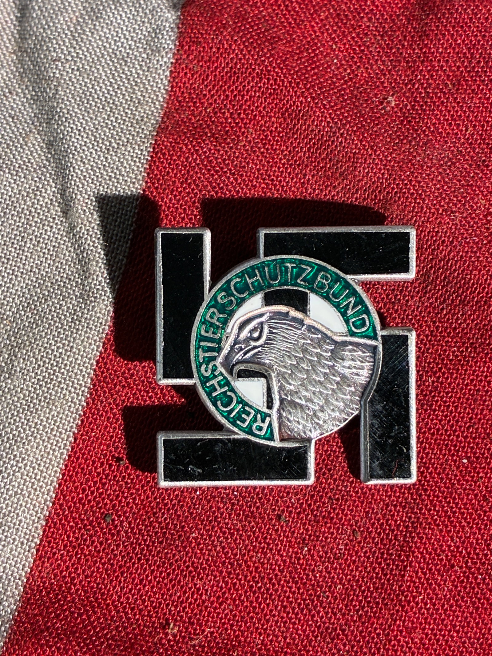 WW2 German Reichstierschutzbund Membership Badge (c. 1934–1945): This enamel-and-metal badge represents membership in the Reichstierschutzbund (Reich Animal Protection League), an organization operating in Nazi Germany that promoted state-directed animal welfare in