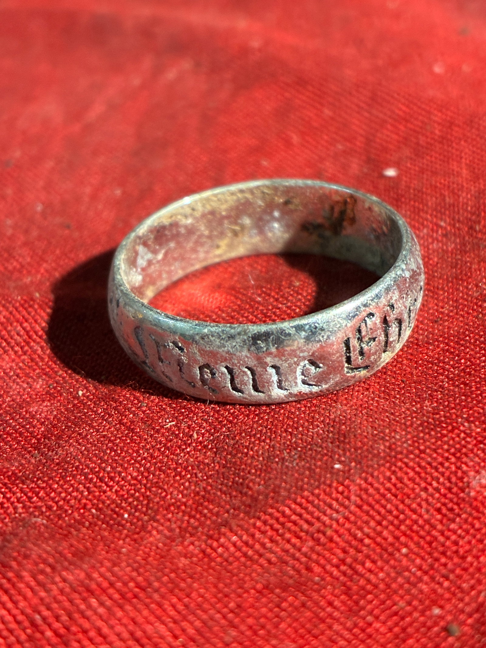 WW2 German Inscribed Band Silver Ring Bearing Nazi-Era Motto: This simple Silver band ring, worn and oxidized with age, bears an engraved German inscription executed in a Gothic script style commonly used during the Nazi period (1933–1945). Rings of this type 