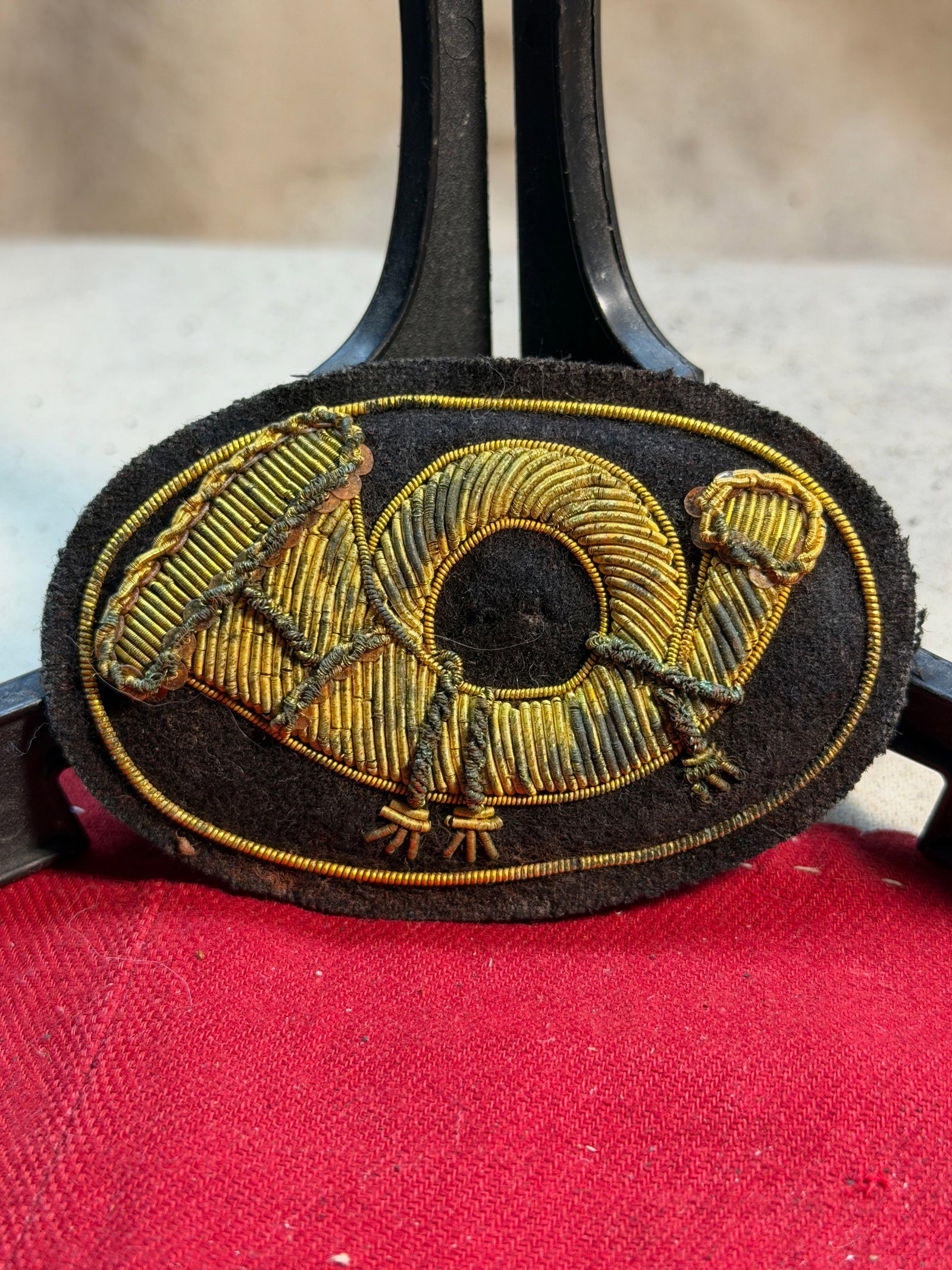 Civil War Infantry Horn Hand-Embroidered Headgear Badge Insignia: This hand-embroidered Civil War infantry horn insignia was worn on the front of Union enlisted men’s kepis and forage caps. The coiled hunting horn, crafted here in rich gold bullion wire on a dark 