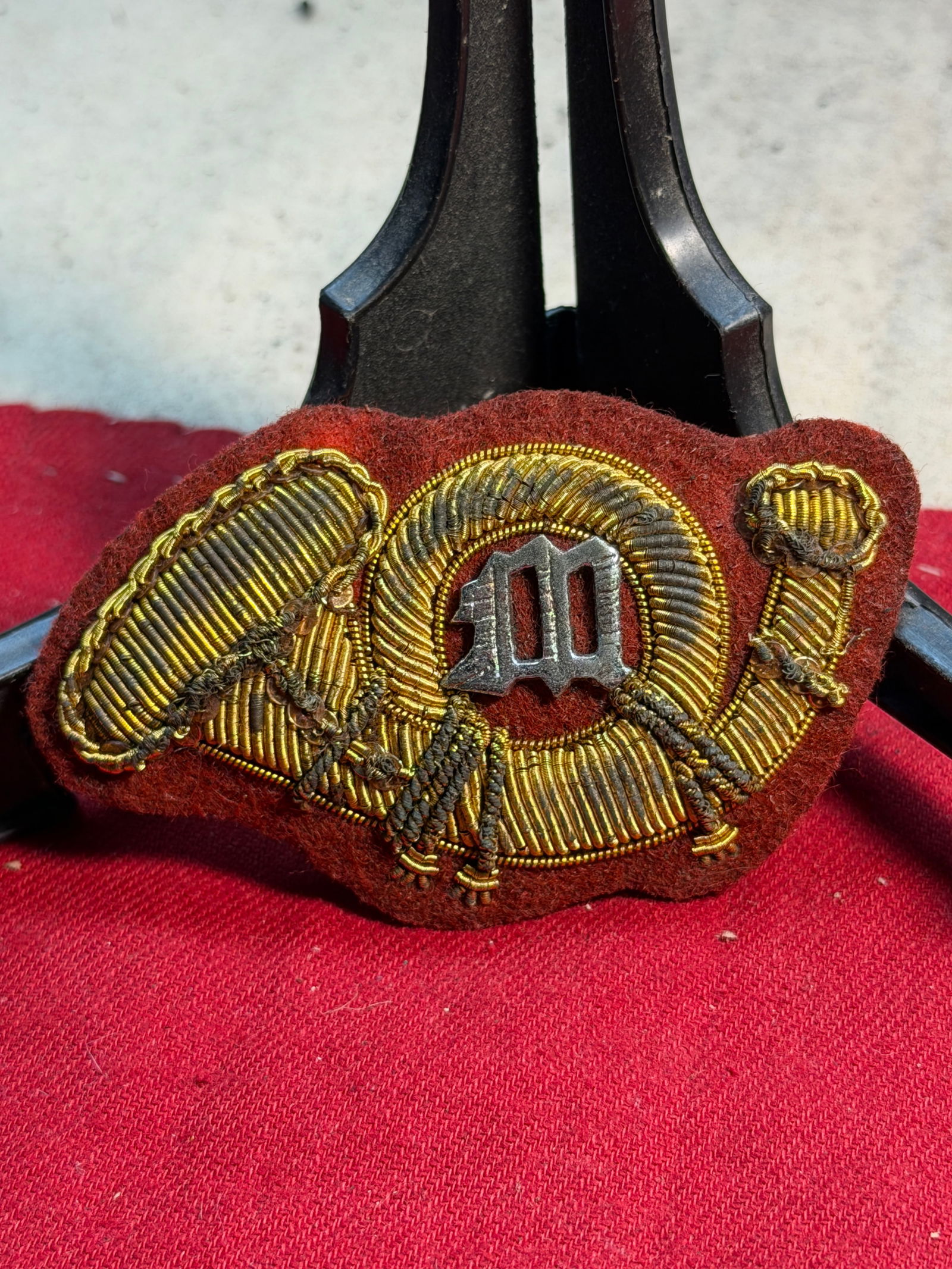 Civil War United States Marine Corps Hat Badge: This rare Civil War–era United States Marine Corps hat badge features the traditional Marine hunting horn motif, rendered in rich gold bullion embroidery on a field of deep red wool—consistent wit