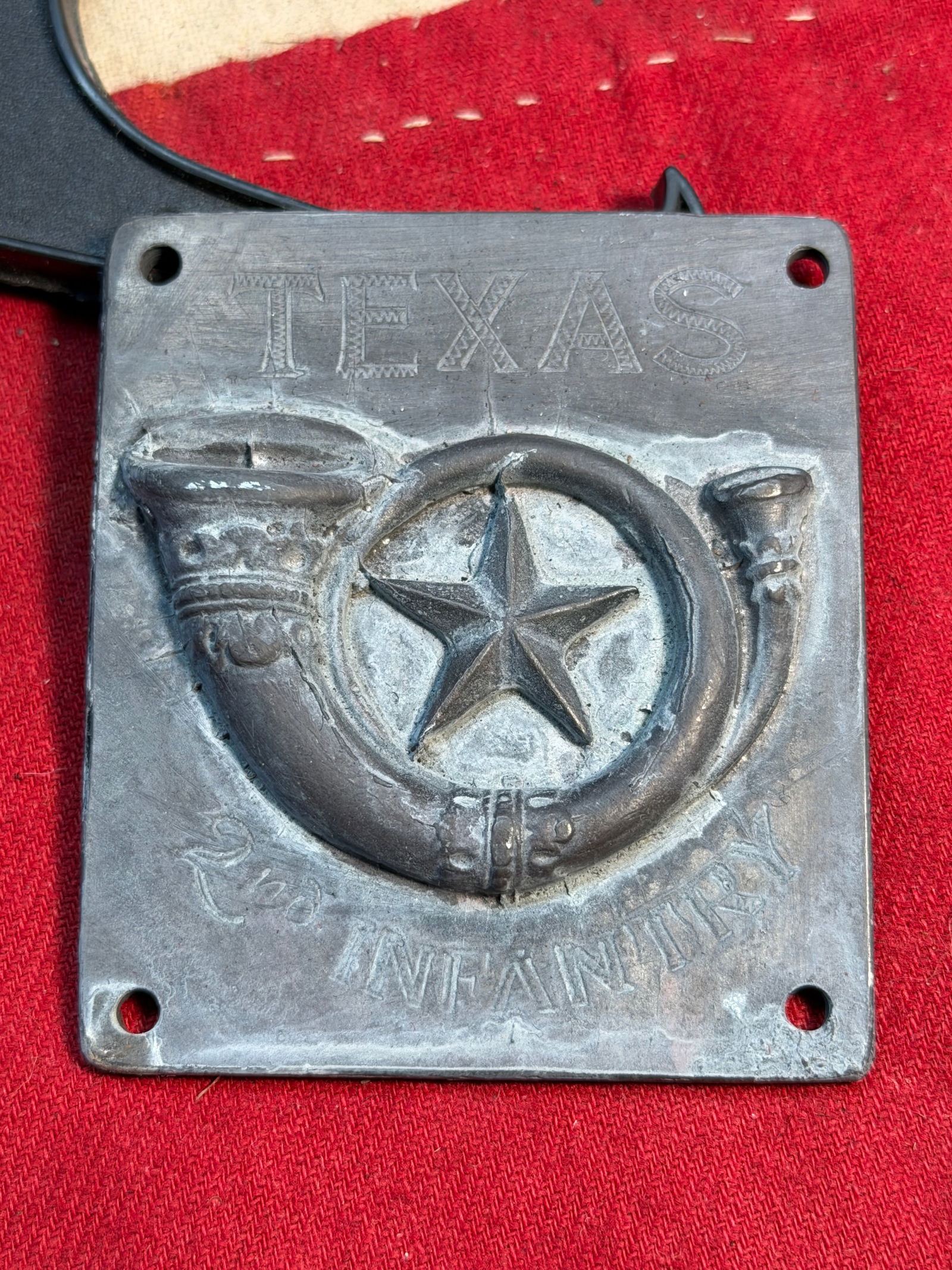 Confederate Civil War Texas 2nd Infantry Plate (1862): This cast-metal plate represents the 2nd Texas Infantry, a Confederate regiment formed early in the Civil War. The design prominently features a five-point Texas Lone Star framed within an infantry hu
