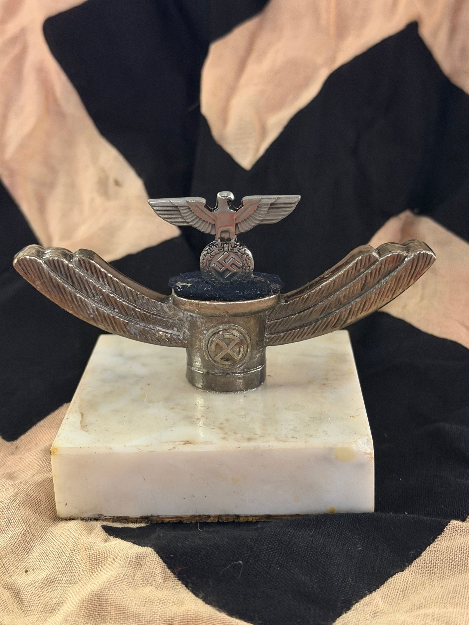 WW2 German Luftwaffe Desk Ornament with German Eagle Motif, Third Reich Period, ca. 1933–1945: This small desktop ornament features a stylized eagle with outstretched wings mounted above a cylindrical pedestal and set on a rectangular marble base. The eagle, a recurring symbol used by the Germa