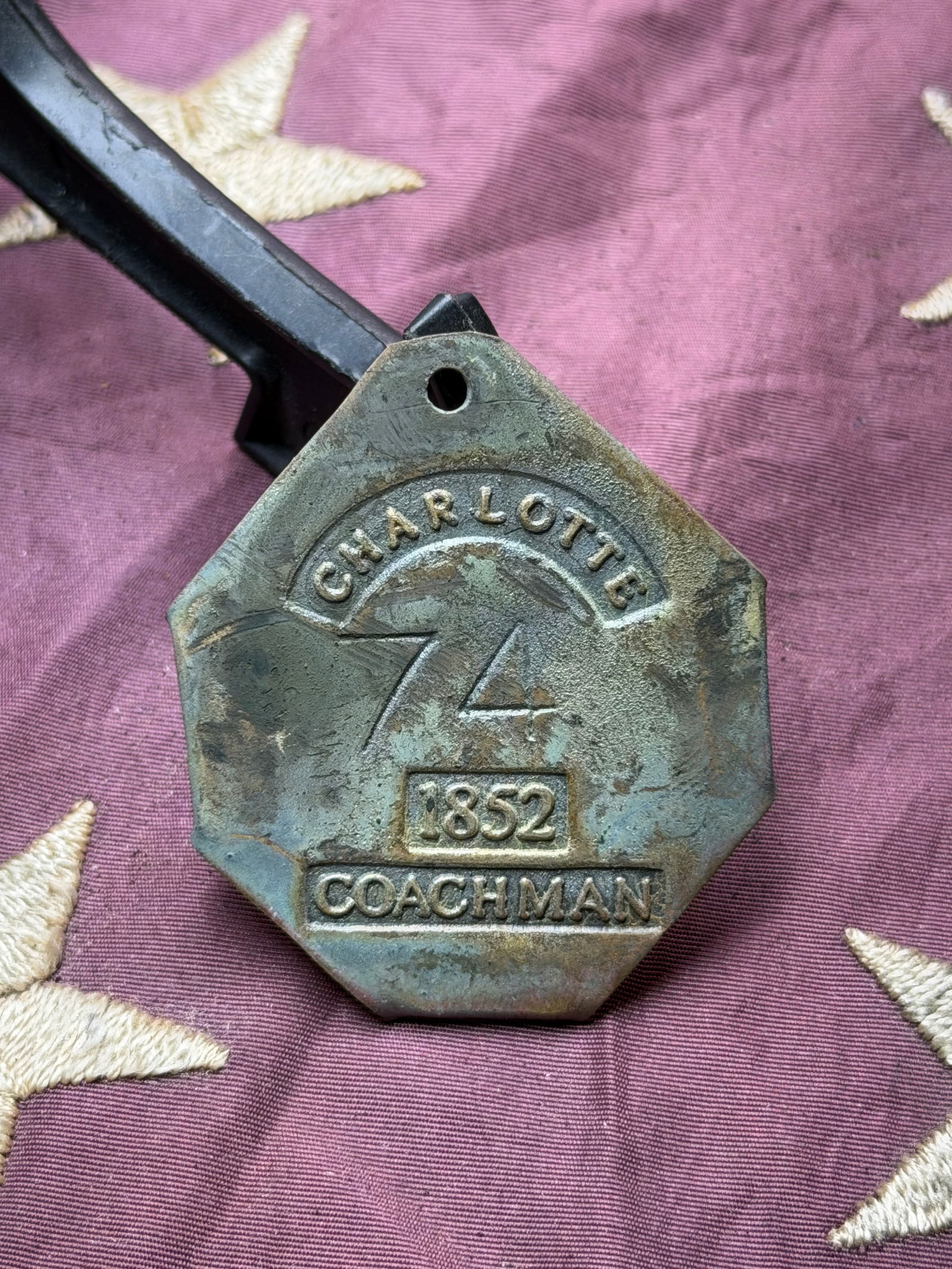 Charleston “Coachman?? Slave Hire Badge, No. 74 (1852): This brass hire badge was issued in Charleston, South Carolina, in 1852 to an enslaved man hired out as a coachman. The badge is stamped “CHARLESTON / 74 / 1852 / COACHMAN” and was worn on the