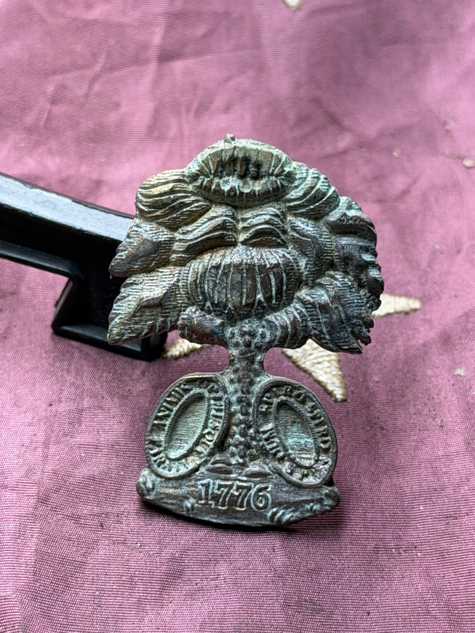 Civil War South Carolina Palmetto Tree Insignia: This brass insignia depicts the palmetto tree, a long-standing symbol of South Carolina, surmounted by a bundled crown and resting above crossed oval shields and the date “1776.” The palmetto