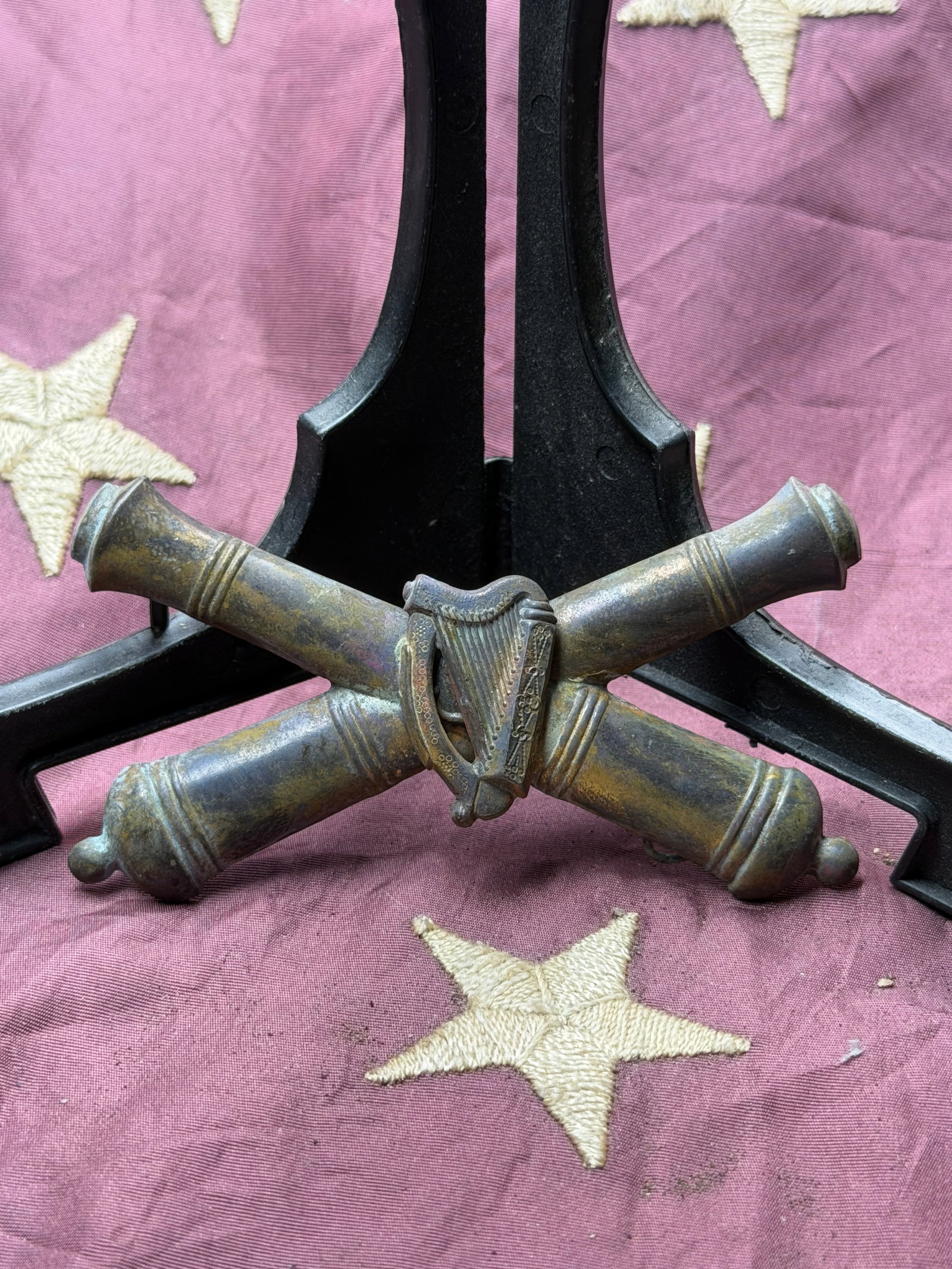 Civil War Irish Artillery Crossed Cannons Badge: This cast-metal crossed cannons badge with central harp is associated with British Army artillery units serving in Ireland, dating to the mid 19th century. The crossed cannon barrels are the long-esta