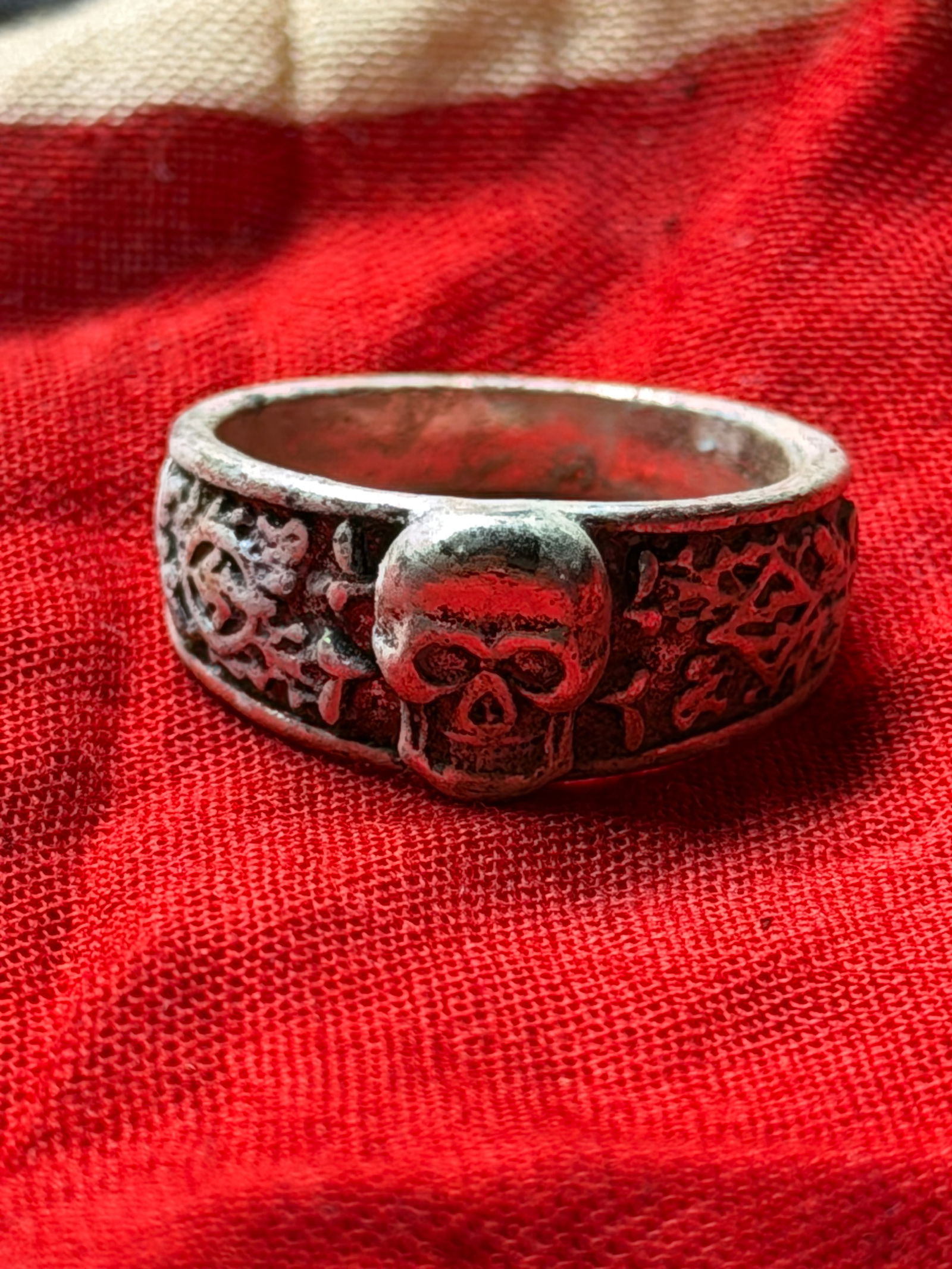WW2 GERMAN TOTENKOPF SS DEATH’S HEAD SILVER RING: Nazi-era Totenkopf (Death’s Head) ring, a form of personal adornment associated with the culture and symbolism of the Third Reich. The ring features a raised skull motif on the bezel, flanked by dec