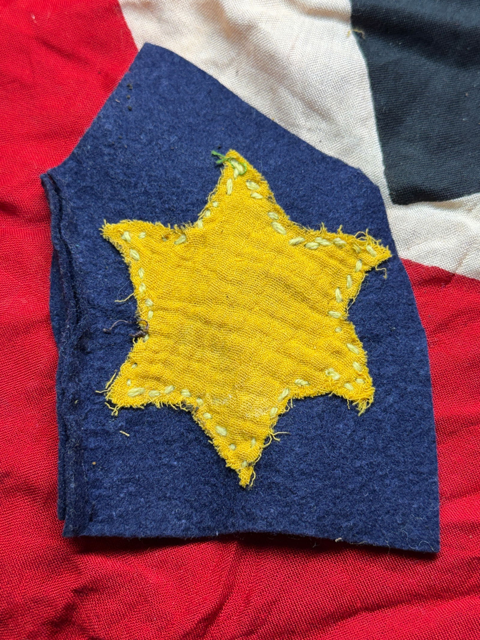 WW2 German Jewish Identification Badge (Yellow Star): This cloth badge is a yellow Star of David appliqué, intended to be sewn onto civilian clothing as a compulsory identification marker for Jews under Nazi racial laws. Beginning in 1939 and expanding