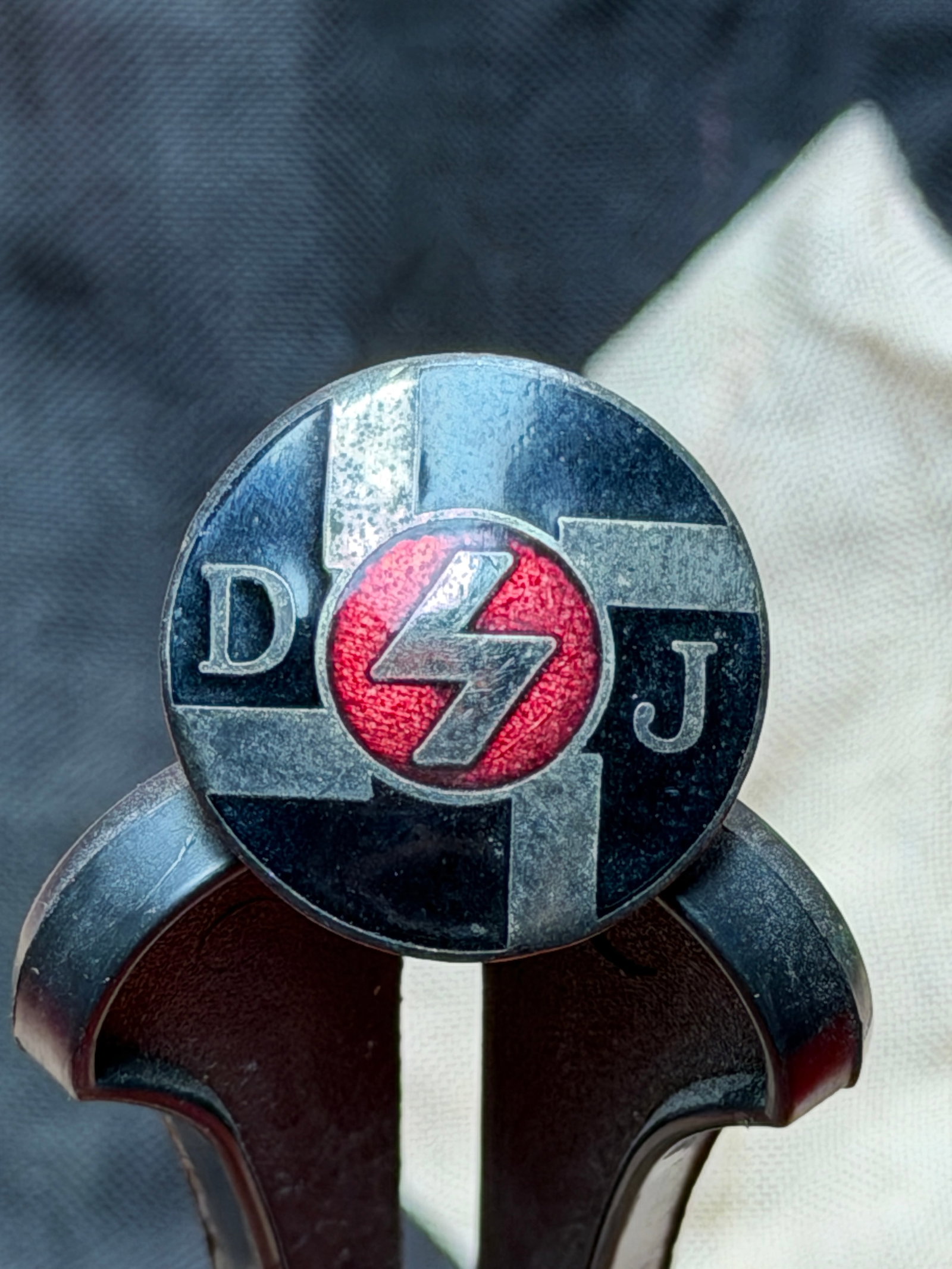 WW2 German Deutsches Jungvolk (DJ) Youth Membership Badge: This circular metal badge is an original membership insignia of the Deutsches Jungvolk (DJ), the junior branch of the Hitler Youth organization in Nazi Germany. The DJ served as the compulsory youth o