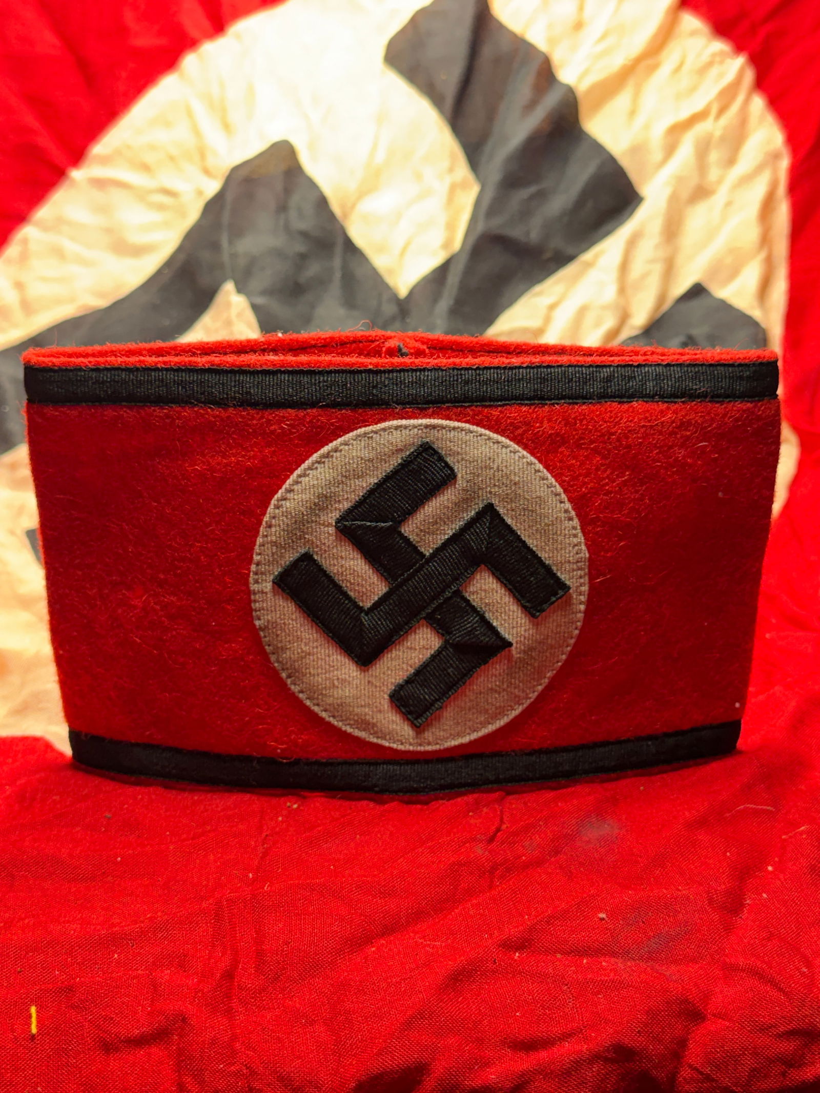 WW2 German National Socialist German Workers’ Party (NSDAP) Armband: This armband is an original uniform insignia associated with the National Socialist German Workers’ Party (NSDAP) in Germany during the Third Reich period (1933–1945). Constructed of red wool felt