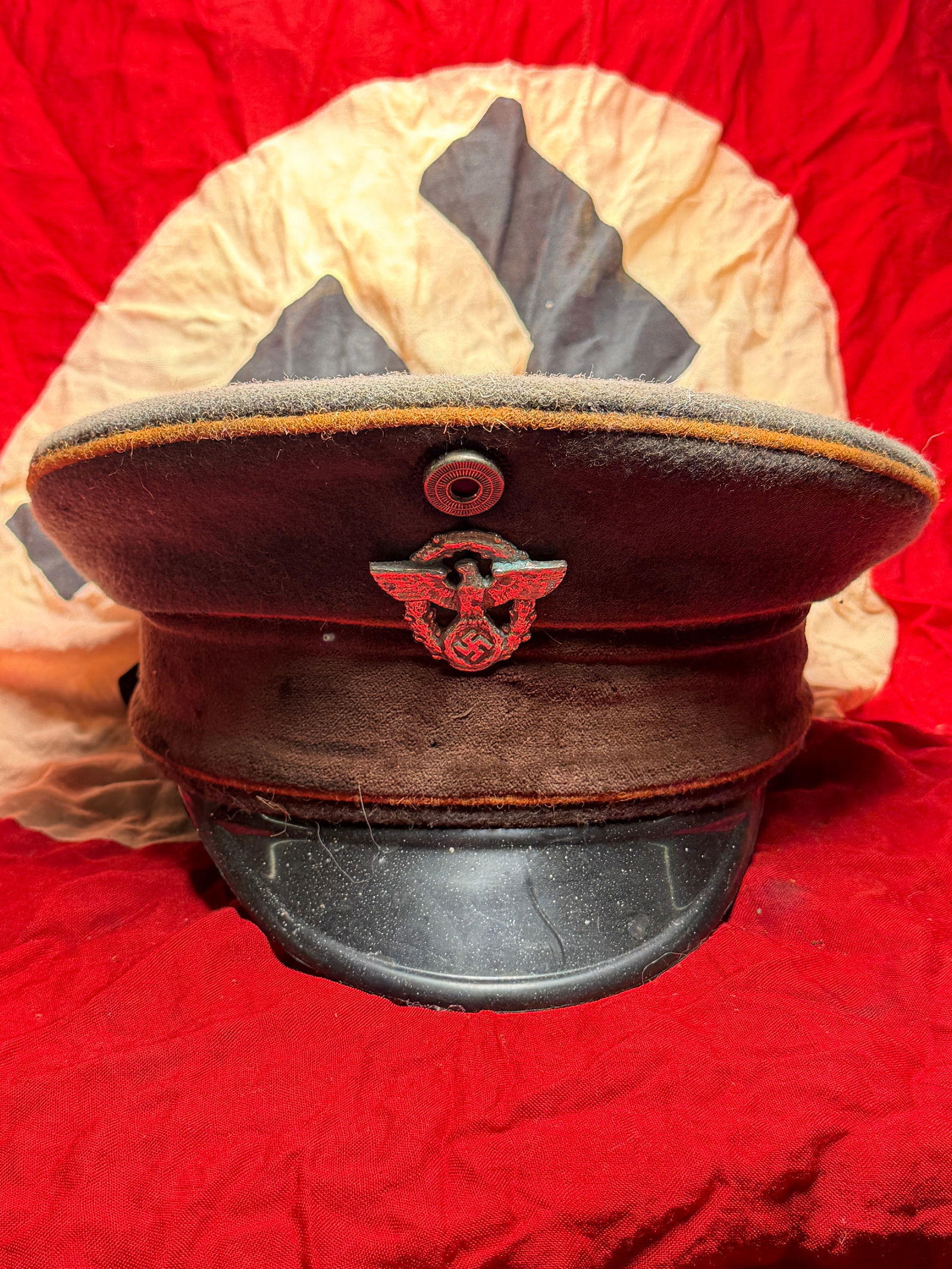 WW2 National Socialist German Workers’ Party (NSDAP) Political Leader Visor Cap: National Socialist German Workers’ Party (NSDAP) during the mid-to-late 1930s. Constructed of feldgrau wool with a stiffened crown and black leather visor, the cap features the NSDAP political eagle