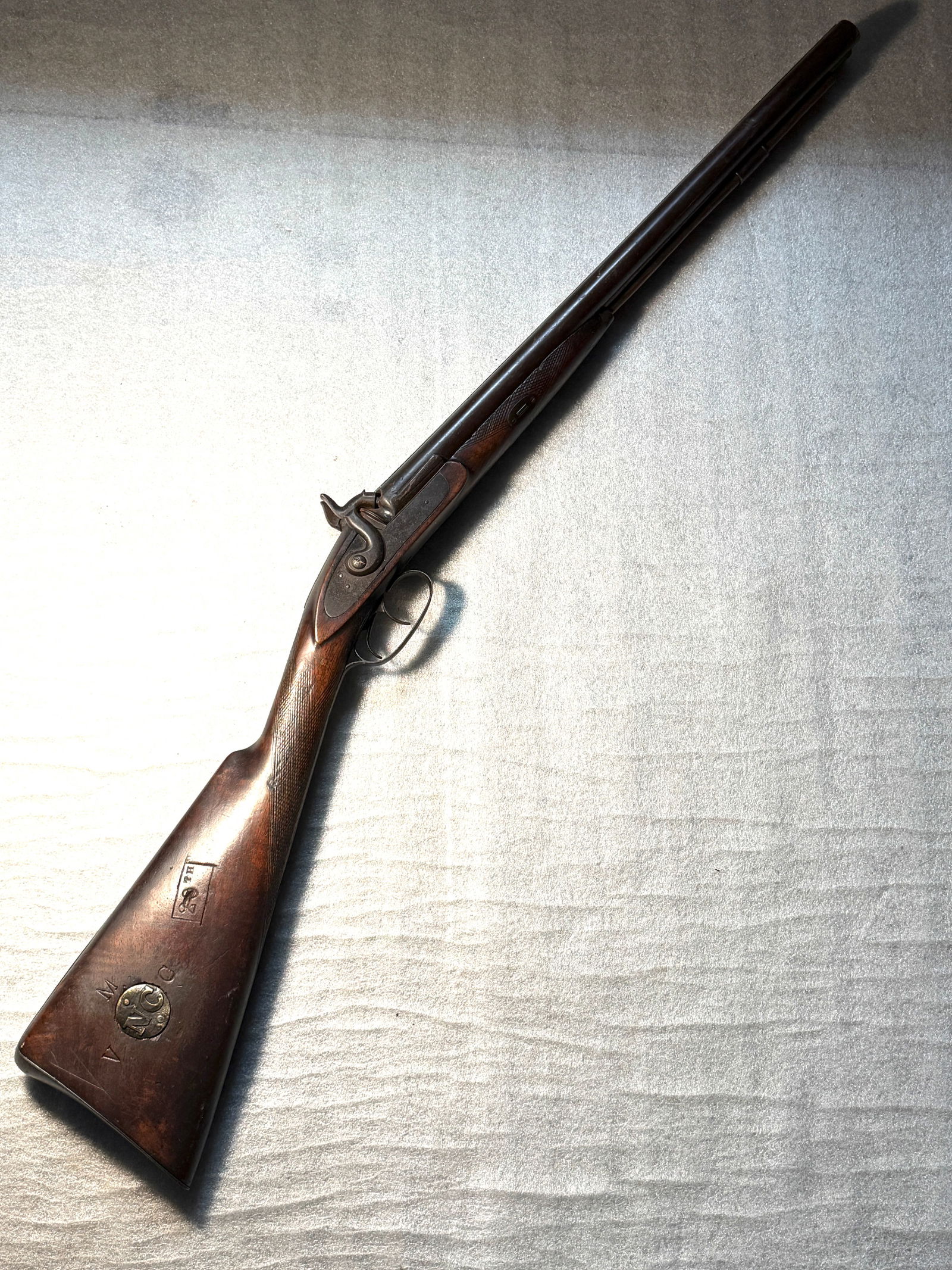Confederate Double-Barrel Percussion Shotgun with North Carolina “NC?? Ownership Disk and Unit: This double-barrel percussion shotgun is a rare and evocative example of a privately owned firearm adapted for Confederate service during the American Civil War (1861–1865). Featuring a side-by-side