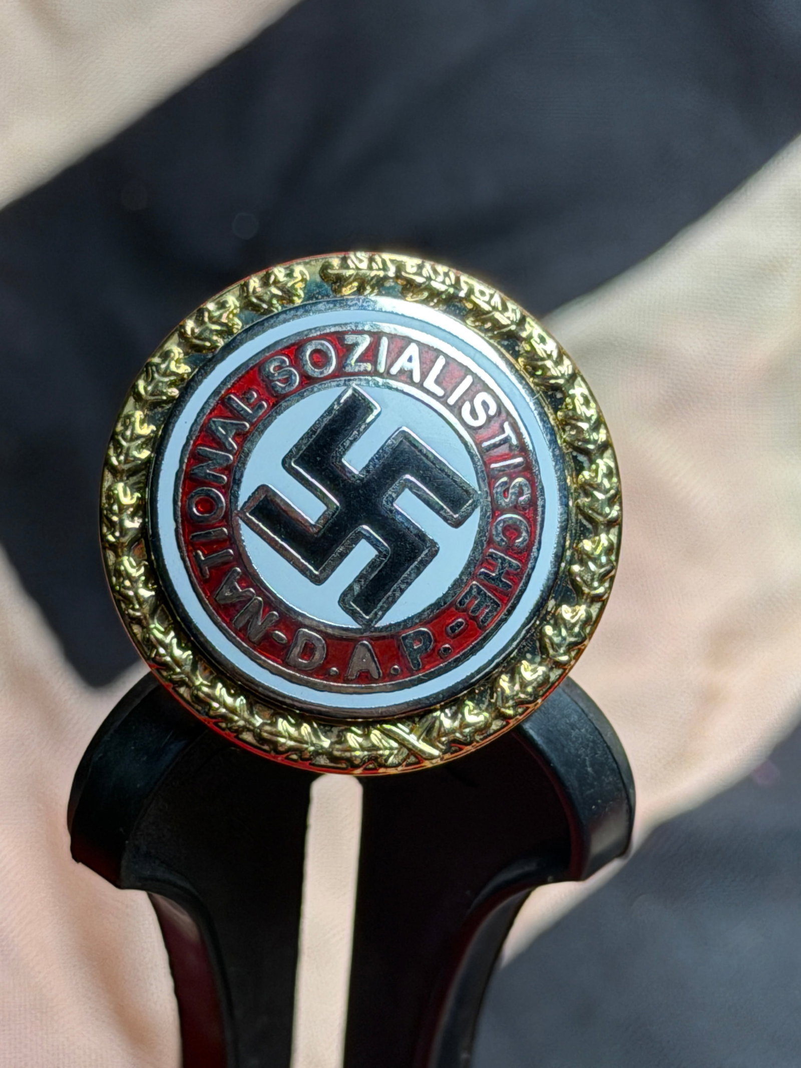 German NSDAP Party Membership Badge (Mitgliedsabzeichen), Numbered, WWII Era: German National Socialist German Workers’ Party (NSDAP) membership badge dating to the Third Reich period (1933–1945). This round enameled badge features the black swastika set within a white fiel