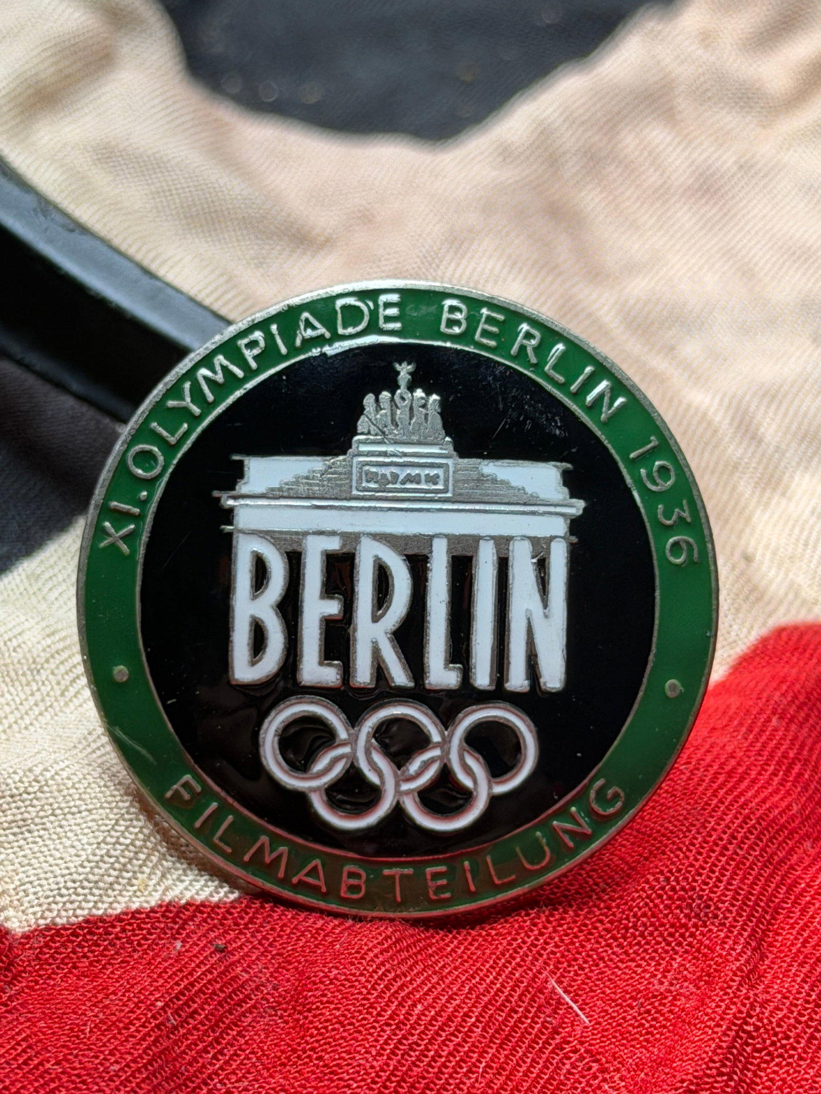 WW2 German Berlin 1936 Olympic Games Film Department Badge By Rob. Neff BERLINW51: This circular enamel badge was produced for the XI Olympiad, Berlin 1936, and is marked “Filmbteilung” (Film Department), indicating its use by personnel associated with the official filming a